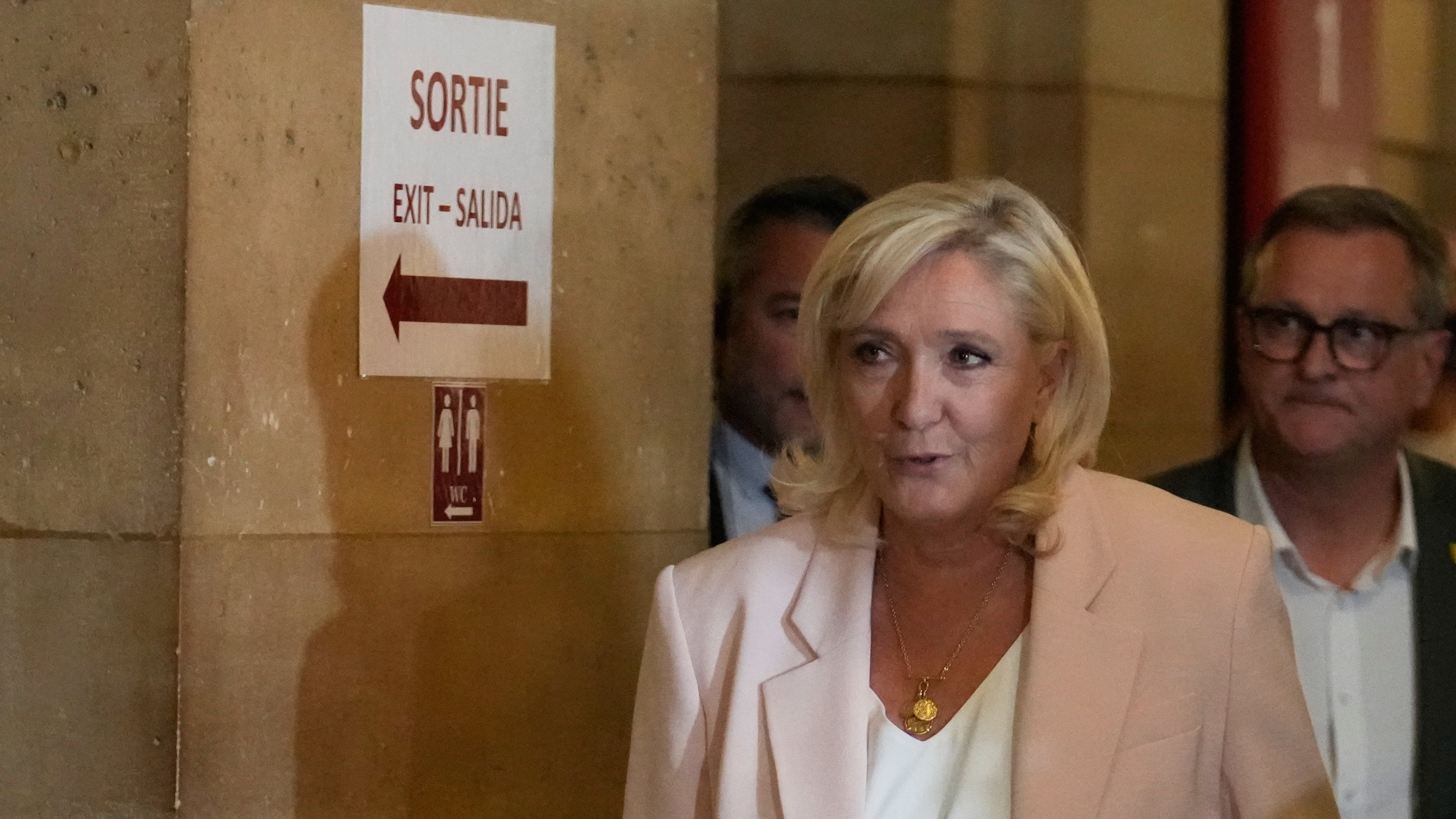 Far-right leader Marine Le Pen arrives at the courtroom for the verdict of her appeals trial, in Paris, France, Tuesday, July. 7, 2026. (AP Photo/Michel Euler)