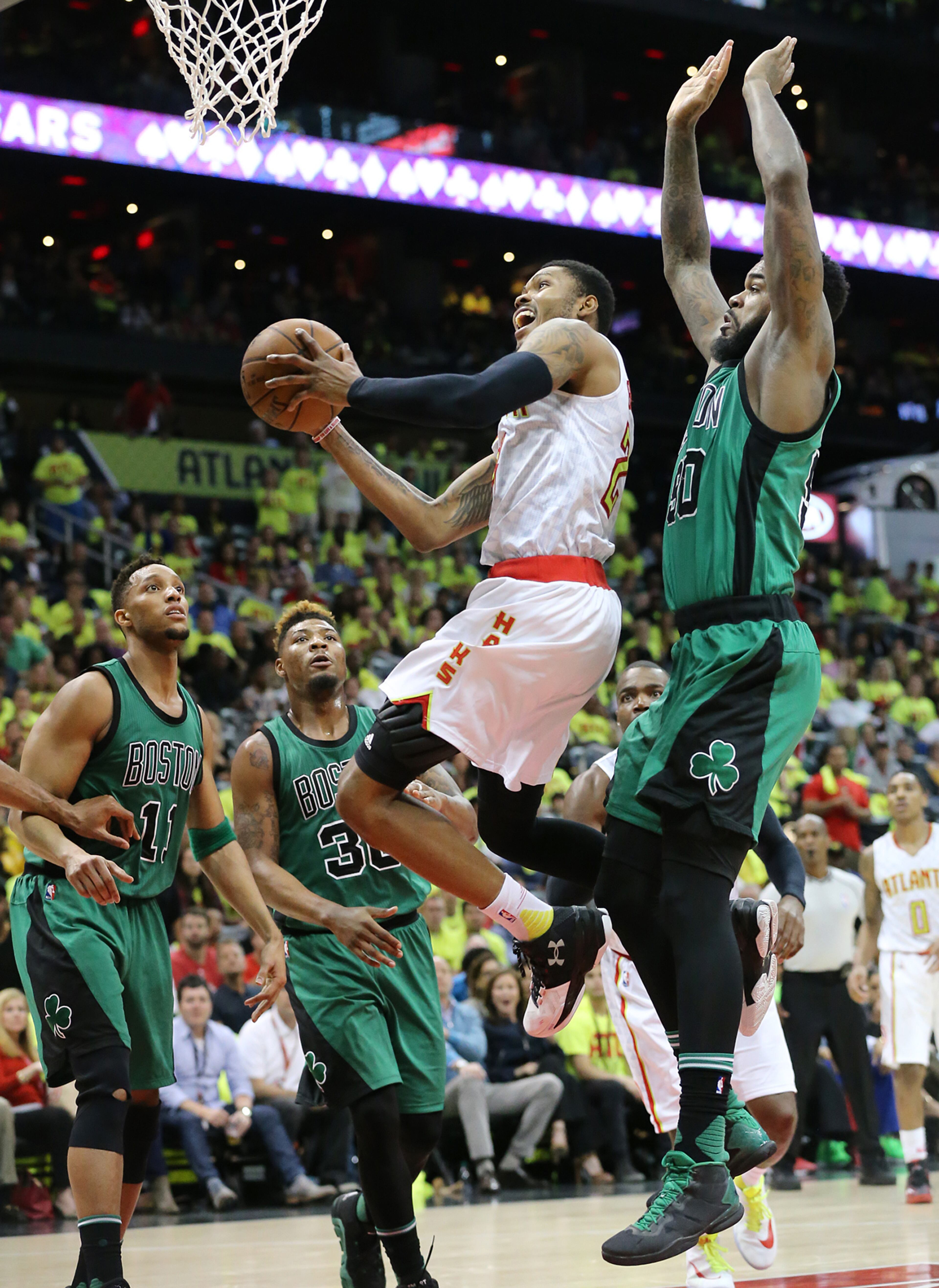 041616 ATLANTA: Hawks Kent Bazemore gets past three defenders for two of his 23 points in the final minutes to beat the Celtics 102-101 in game one of their NBA Eastern Conference first round playoff game at Philips Arena on Saturday, April 16, 2016. Curtis Compton / ccompton@ajc.com