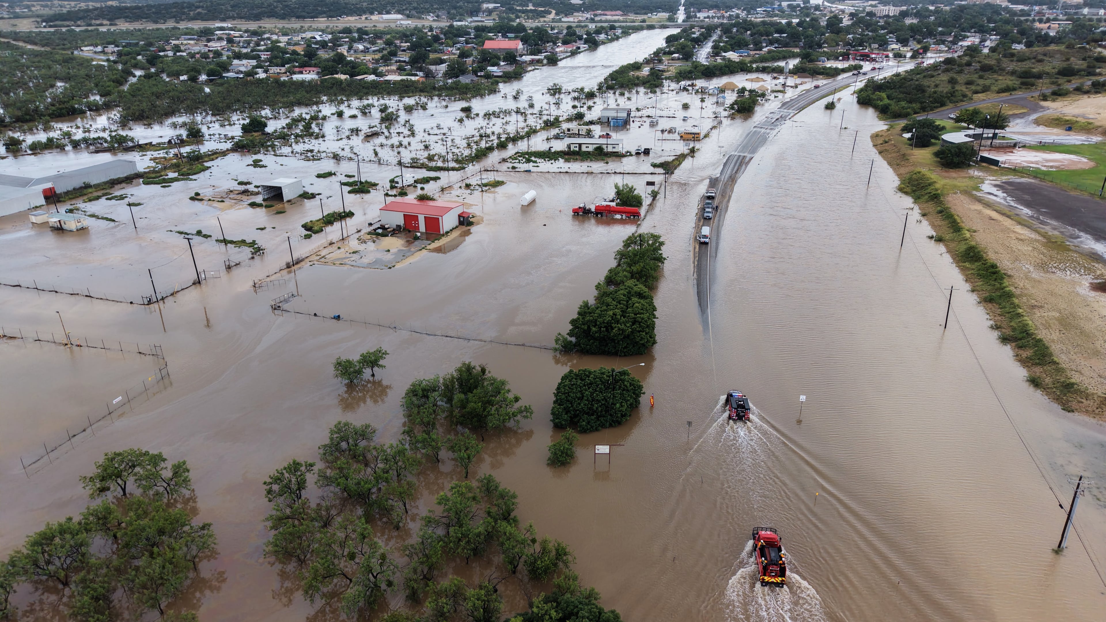 An aerial views shows flooding on Friday, July 17, 2026, in Ozona, Texas. (AP Photo/Gerald Herbert)