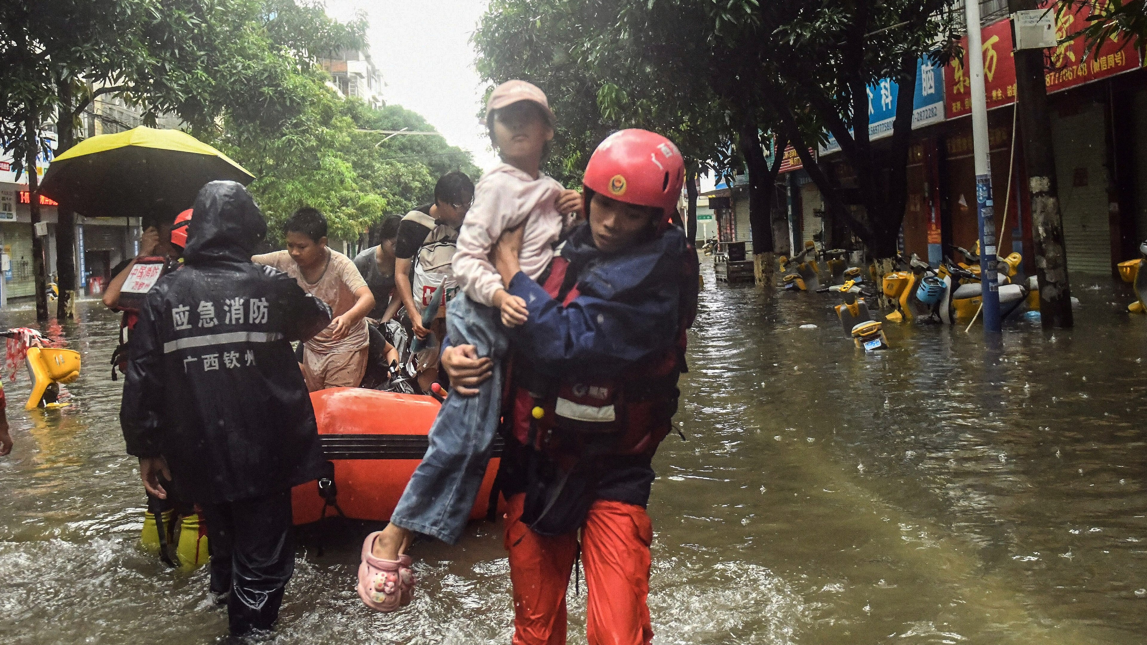 In this photo released by Xinhua News Agency, rescuers evacuate stranded residents in the aftermath of tropical storm Maysak in Qinzhou City, south China's Guangxi Zhuang Autonomous Region Tuesday, July 7, 2026. (Zhang Ailin/Xinhua via AP)