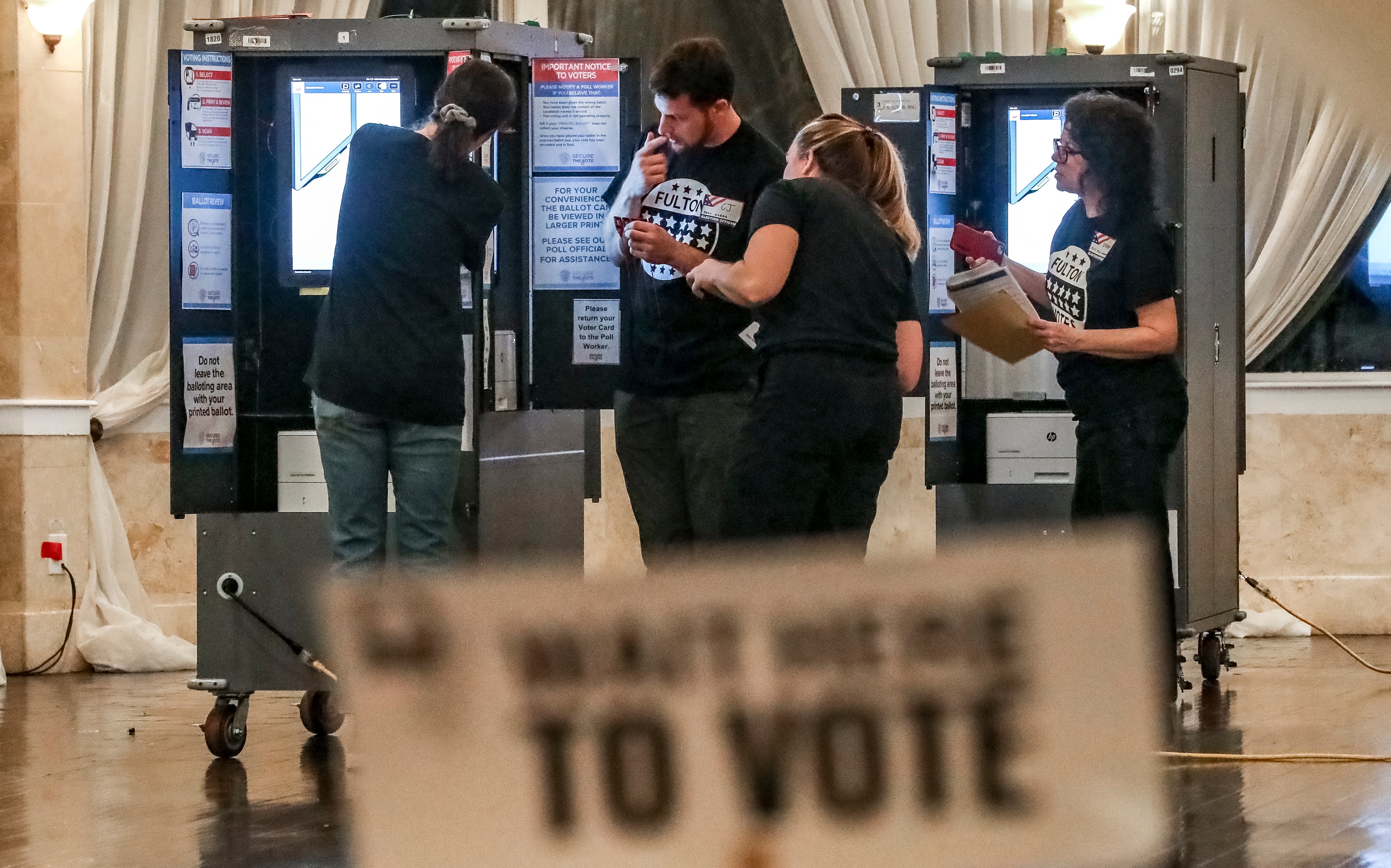 Poll workers prepare for voters in November 2022 at the Park Tavern in Atlanta. (John Spink/AJC)
