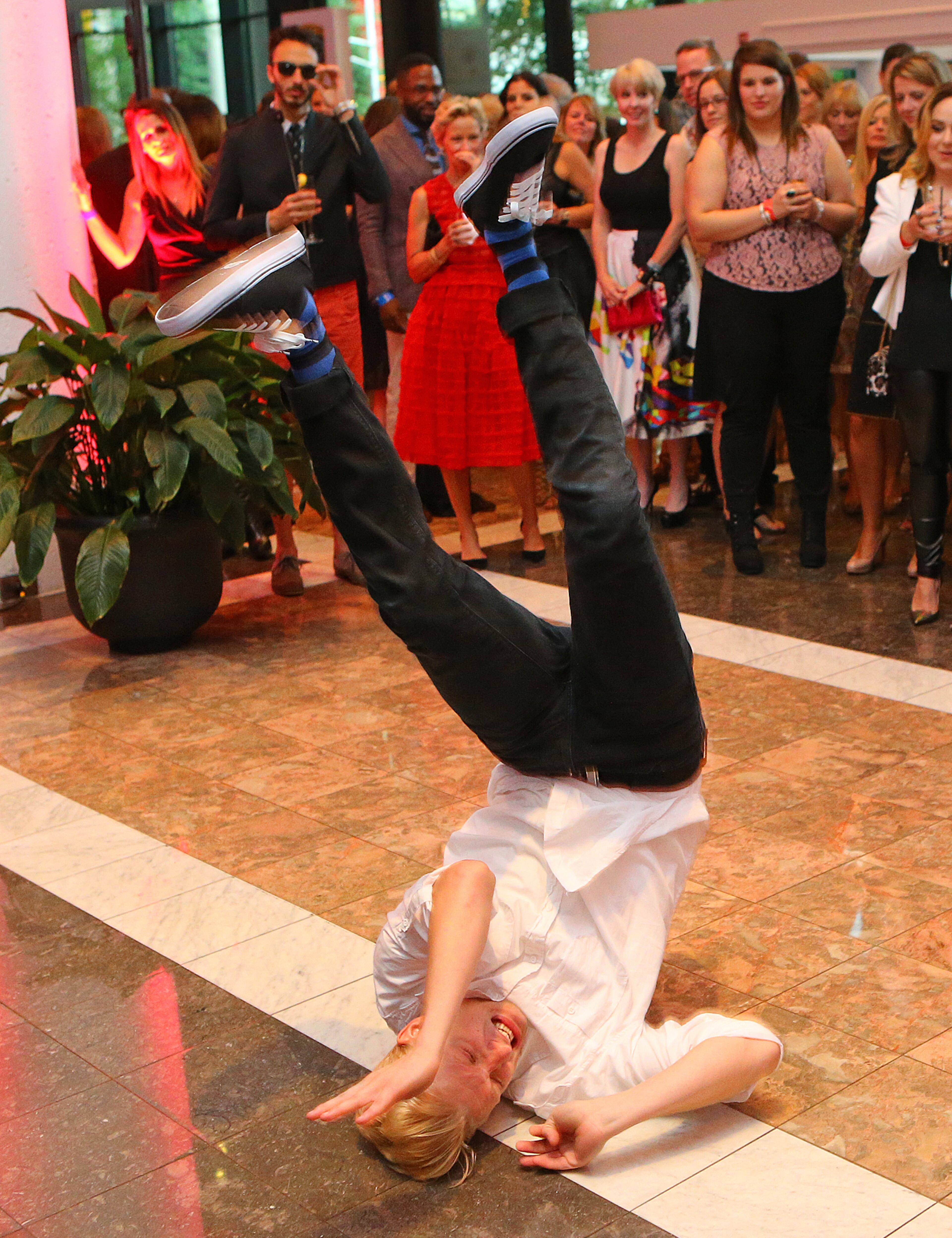 A break dancer with Rogues and Rebels performs for guests before the Jeffrey Cares Fashion Show Monday, Aug. 25, 2014, in Atlanta. The show raises awareness and funds for its beneficiaries the Susan G. Komen for the Cure Greater Atlanta Affiliate and the Atlanta AIDS Fund. CURTIS COMPTON / CCOMPTON@AJC.COM