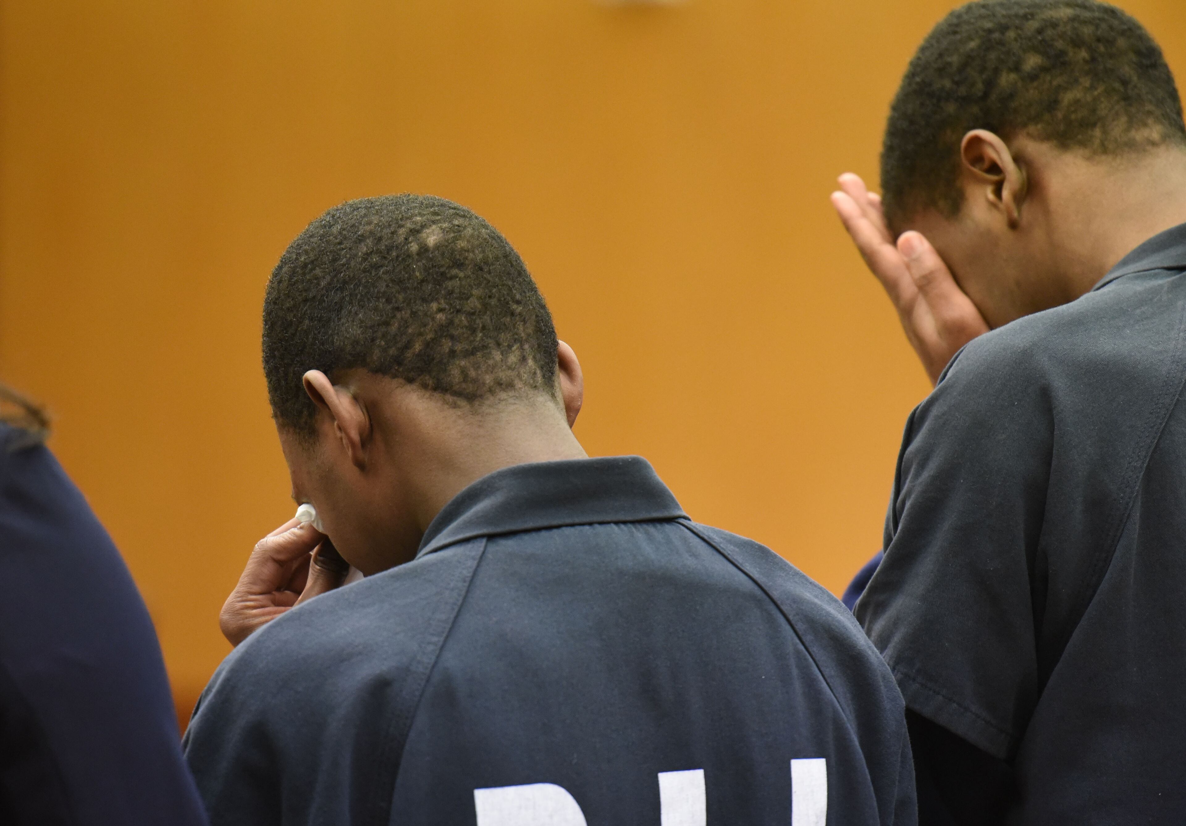 Veshawn Smith, 15, and Trequan Sutton, 16, weep as they stand with their lawyers in front of Judge Henry M. Newkirk at Fulton County Superior Court on Thursday, Jan. 28, 2016. They pleaded guilty in a home invasion case. HYOSUB SHIN / HSHIN@AJC.COM