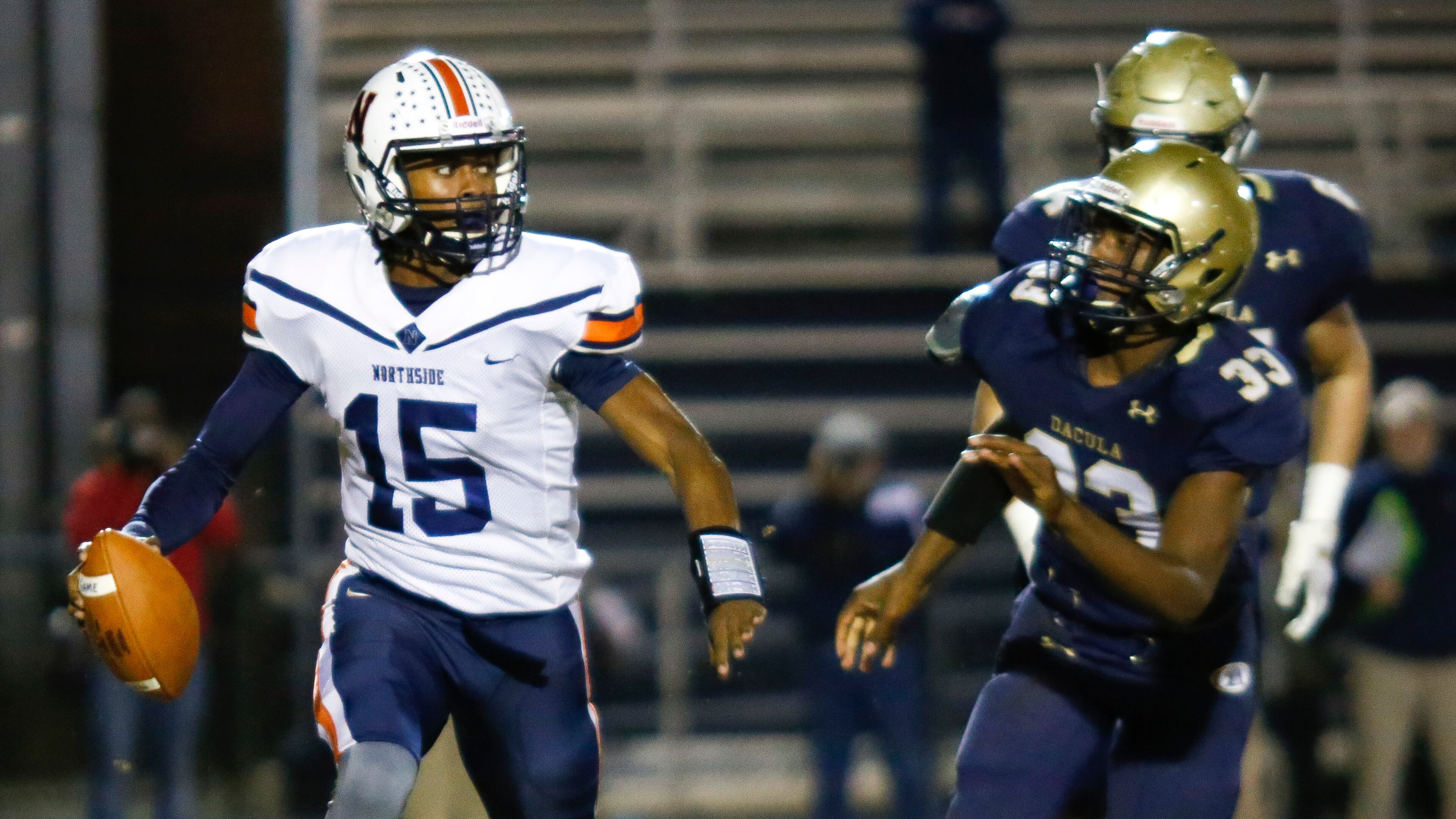 Northside Warner Robins quarterback Jadin Daniels (15) looks for a receiver under pressure from Dacula defenders during Friday's Class AAAAAA semifinal in Dacula. (Casey Sykes/Special)