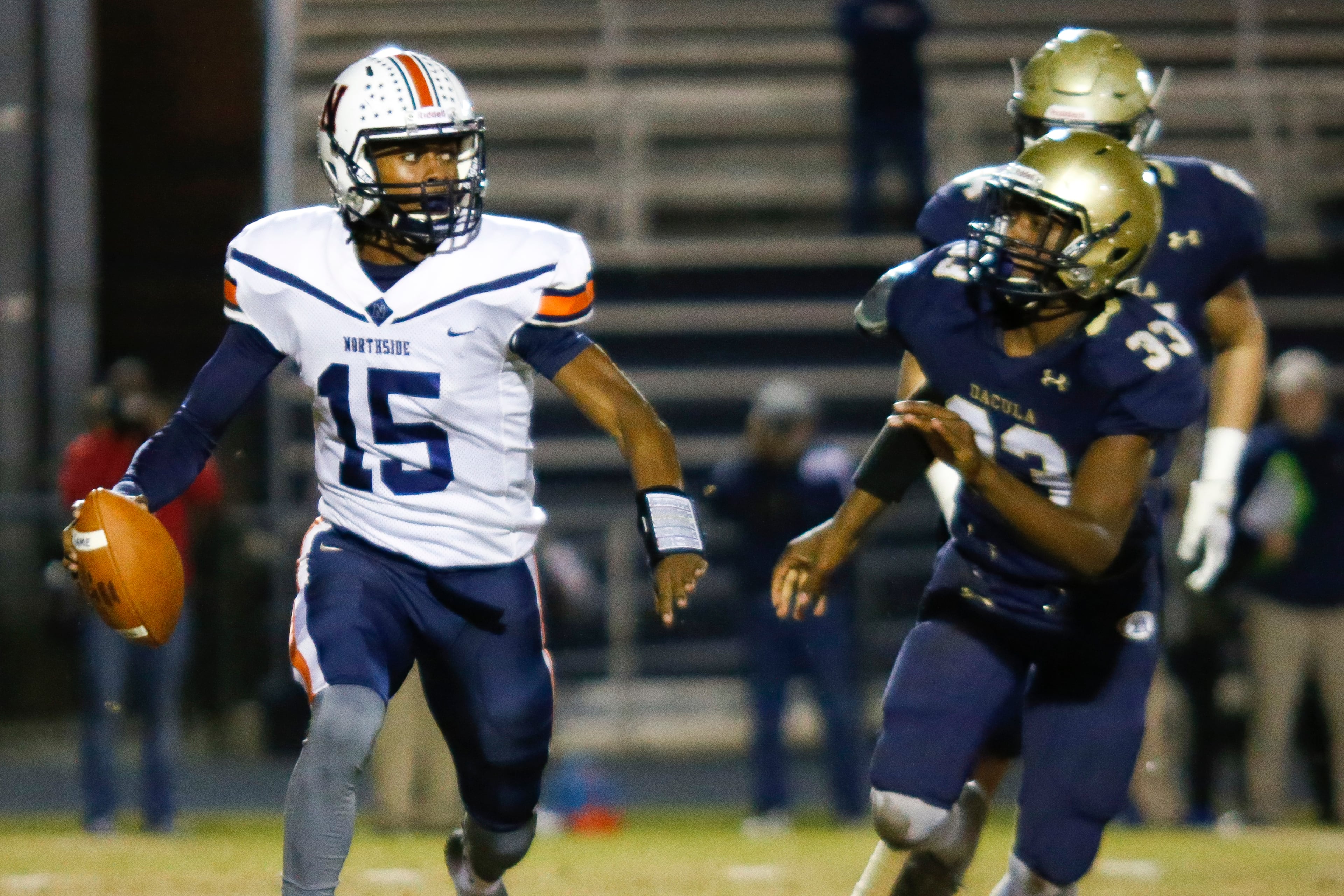 Northside Warner Robins quarterback Jadin Daniels (15) looks for a receiver under pressure from Dacula defenders during Friday's Class AAAAAA semifinal in Dacula. (Casey Sykes/Special)