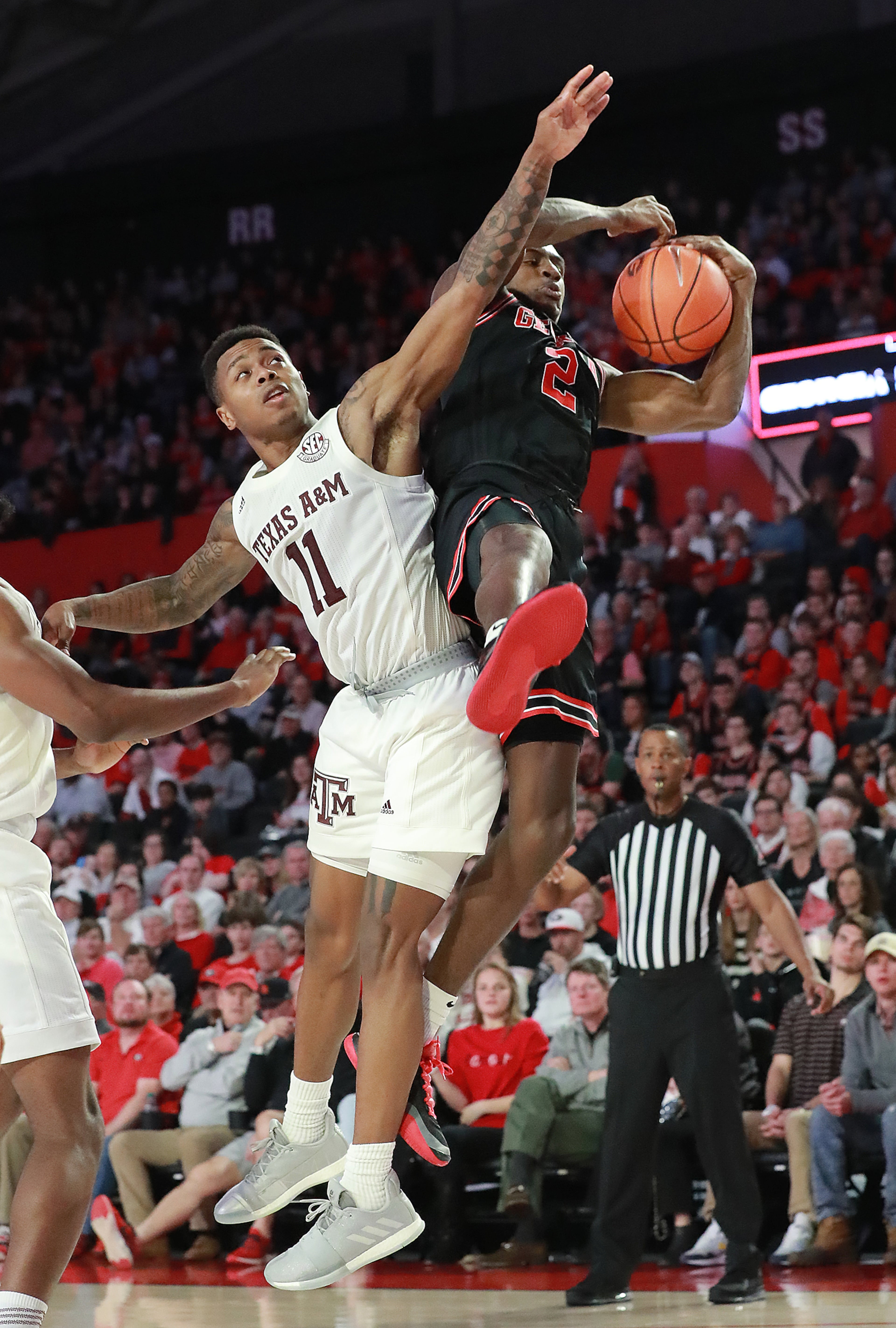Georgia guard Jordan Harris collides with Texas A&M guard Wendell Mitchell while grabbing a offensive rebound during a 63-48 Georgia victory in a NCAA college basketball game on Saturday, Feb. 1, 2020, in Athens. Curtis Compton ccompton@ajc.com
