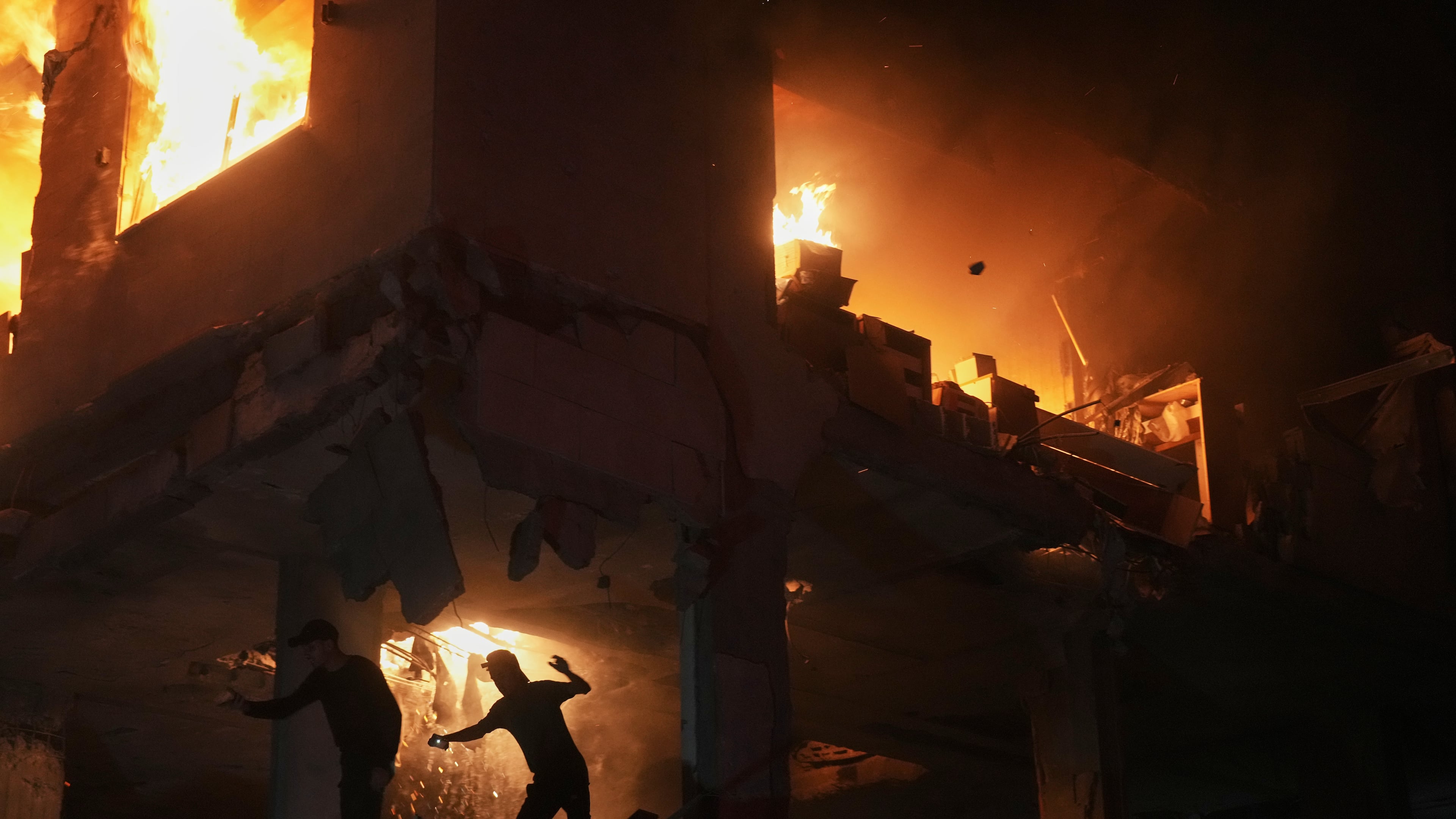 Palestinians react to a fire following an Israeli strike on a residential building in the Rimal neighborhood of Gaza City, Friday, May 15, 2026. (AP Photo/Jehad Alshrafi)
