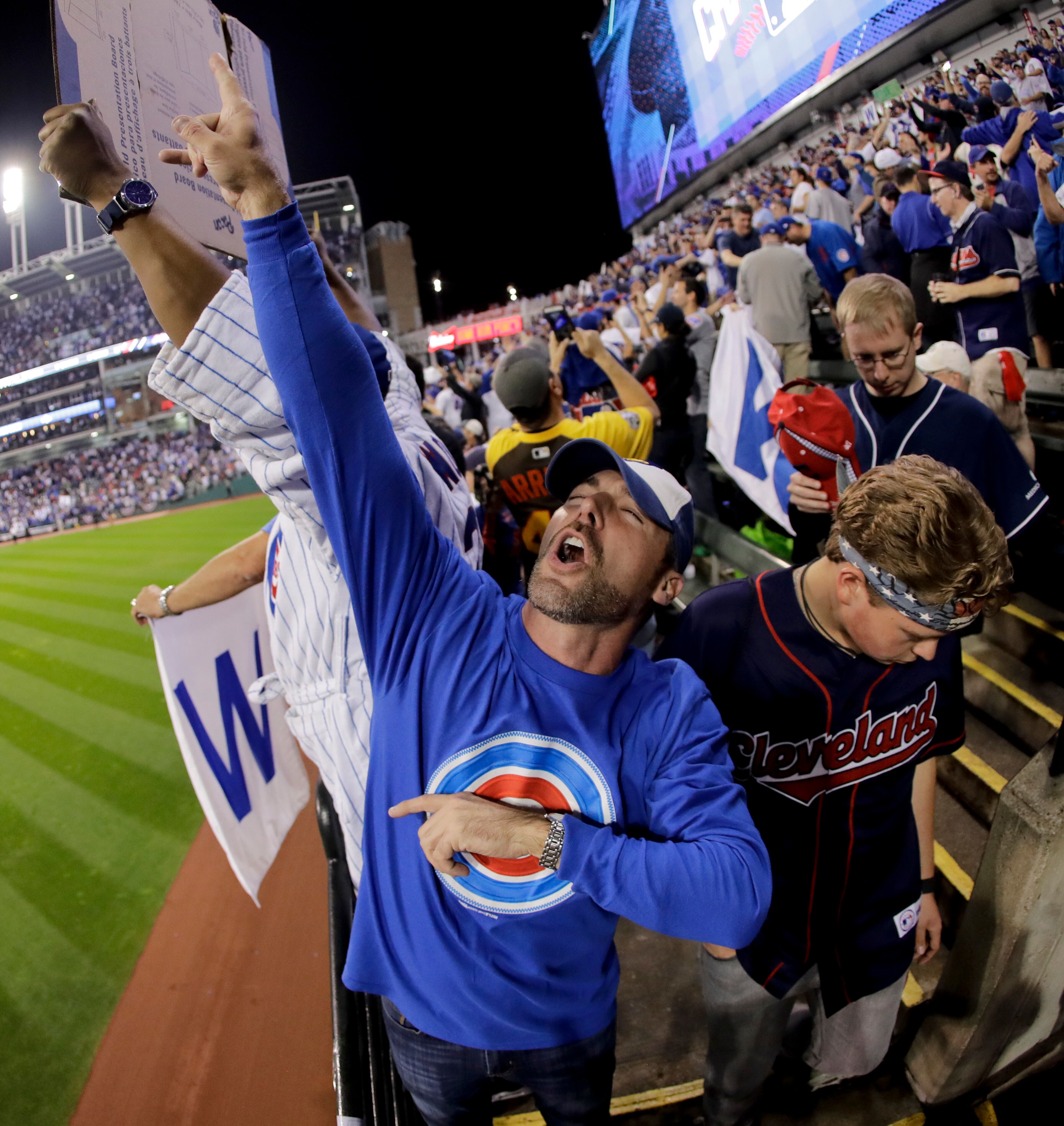 Fan react after the Chicago Cubs won Game 7 of the Major League Baseball World Series against the Cleveland Indians Thursday, Nov. 3, 2016, in Cleveland. The Cubs won 8-7 in 10 innings to win the series 4-3. (AP Photo/Charlie Riedel)