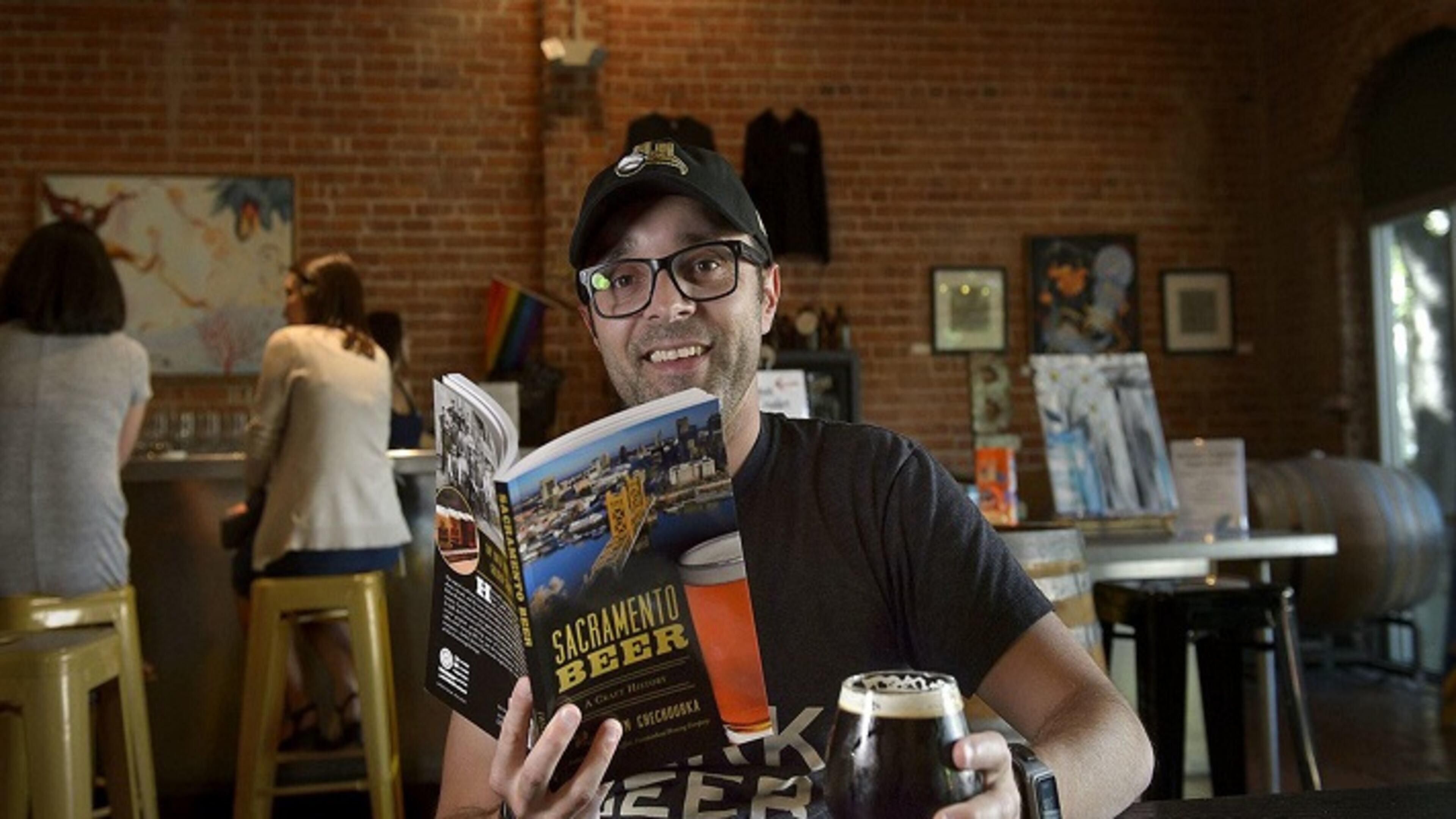 Author of the new book "Sacramento Beer: A Craft History" Justin Chechourka enjoys a glass of beer at Big Stump brewery in Sacramento, Calif. on Friday, May 4, 2018. (Randall Benton/Sacramento Bee/TNS)
