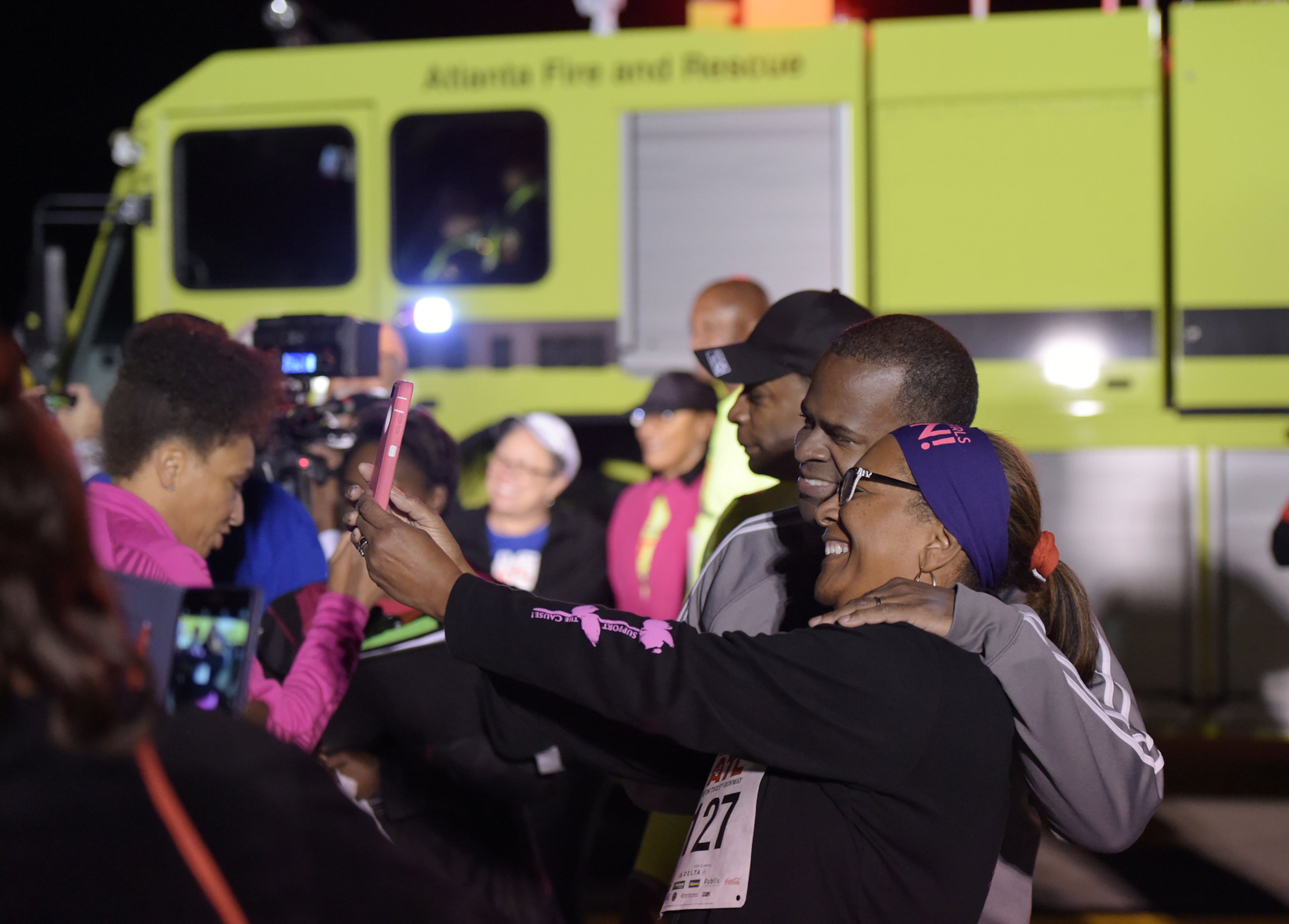 OCTOBER 17, 2015 ATLANTA Cheryl Burnside of Tyrone, takes a selfie with Mayor Kasim Reed before the race. Reed and United Way President Milton Little joined more than 2,000 runners at the Mayor’s Inaugural 5K on the 5th Runway at the world’s busiest airport Saturday, October 17, 2015. Airport officials shut down the 5th runway (Runway 10/28) until 8:15 am so runners and walkers could exit the course. All proceeds from the event will benefit United Way of Greater Atlanta. Major sponsors of The Mayor’s Inaugural 5K on the 5th Runway include Delta Air Lines, The Coca-Cola Company, Enterprise Rental Car, Georgia International Convention Center, MARTA, and Publix. Over $123,000 was raised, said airport spokesman Reese McCranie. The race's overall winner was Andrew Murfee, 15, a Woodward Academy student. KENT D. JOHNSON/KDJOHNSON@AJC.COM