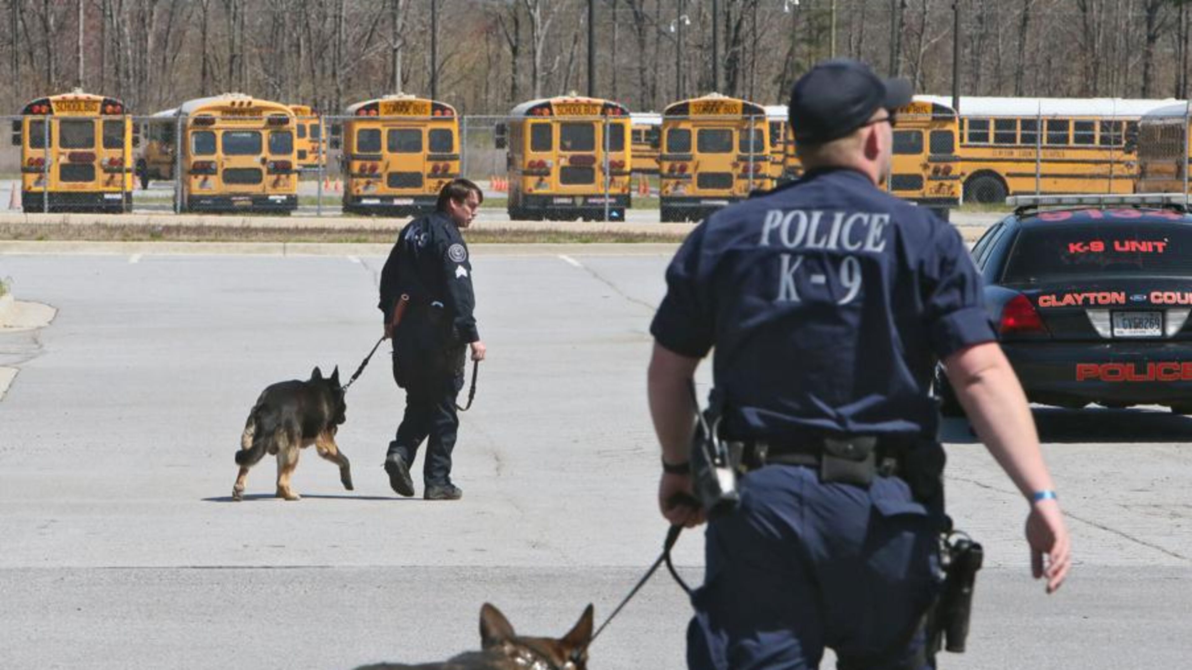 A Clayton County police K-9 unit sweep the local school district’s high schools on March 26, 2014. The Cherokee County School Board has decided to transfer its school police K-9 to the Cherokee County Sheriff’s Office. BOB ANDRES / AJC FILE