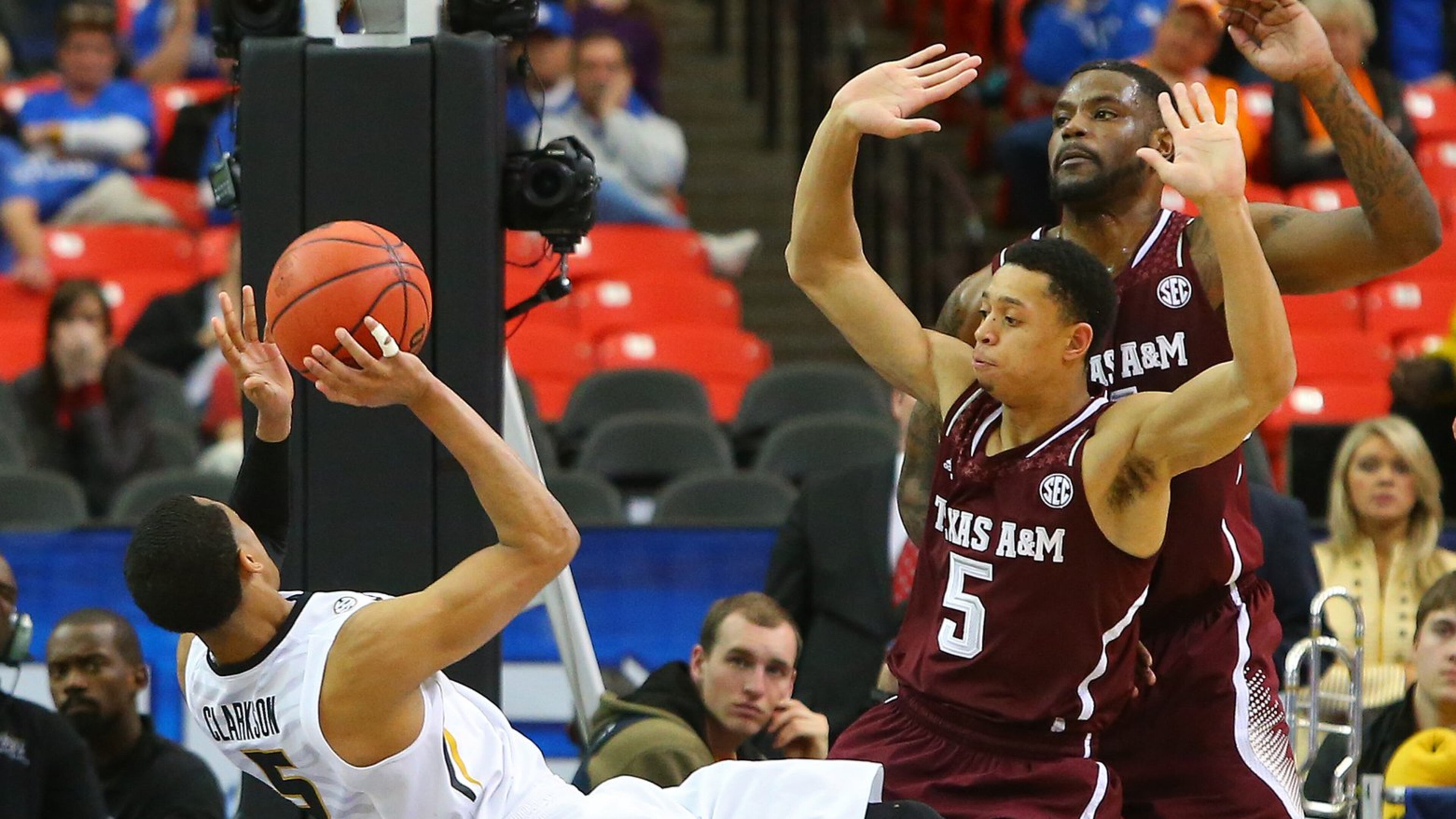 Missouri guard Jordan Clarkson draws the foul from Texas A&M guard Jordan Green in the first overtime in their SEC men’s tournament game Thursday, March 13, 2014, in Atlanta. Missouri won 91-83 in double overtime. CURTIS COMPTON / CCOMPTON@AJC.COM
