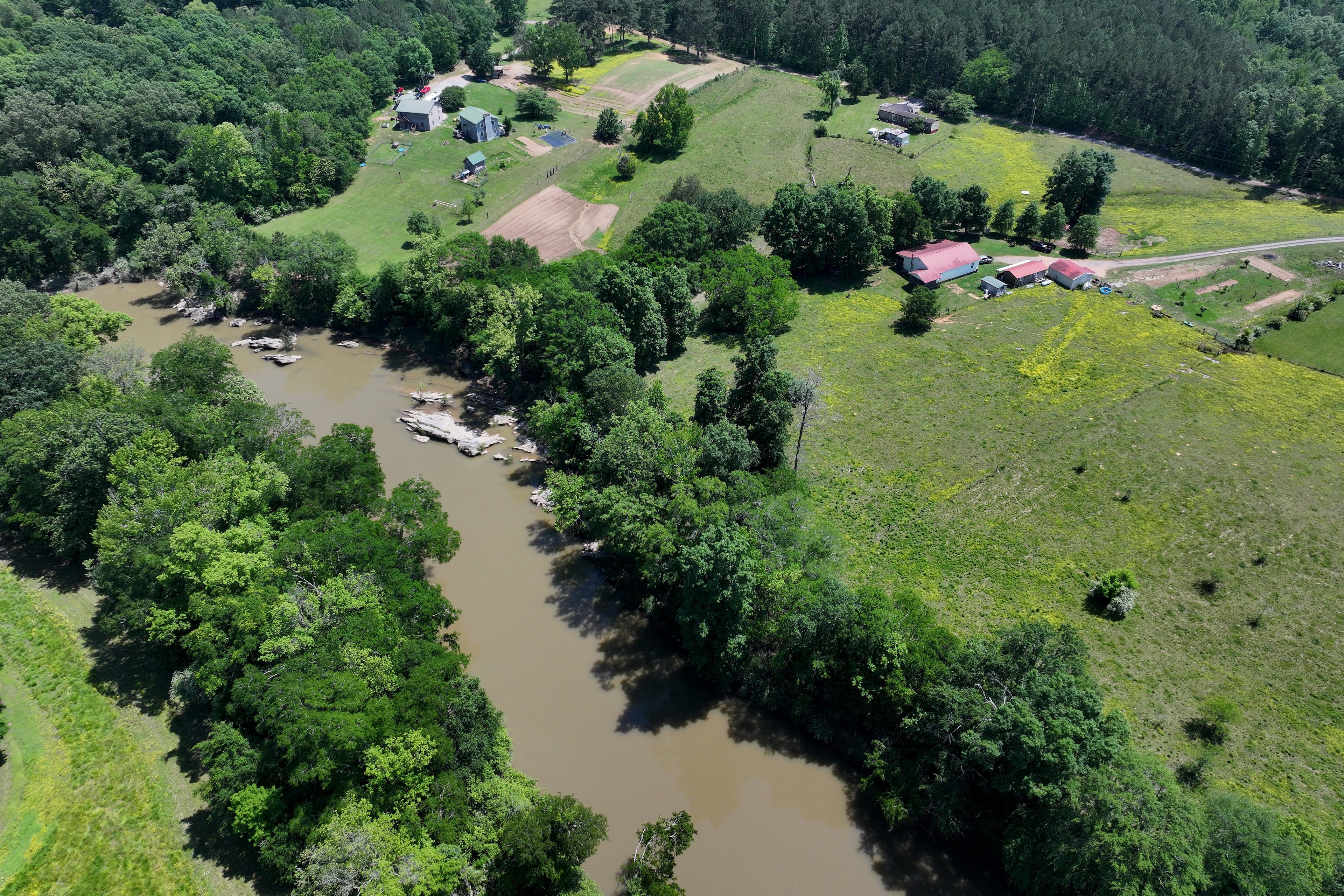 The Conasauga River fuels the water-hungry carpet industry and provides drinking water to thousands of people. The river's waters flow past Dalton and several other downstream communities and are contaminated with stain-blocker chemicals. (Hyosub Shin / AJC)