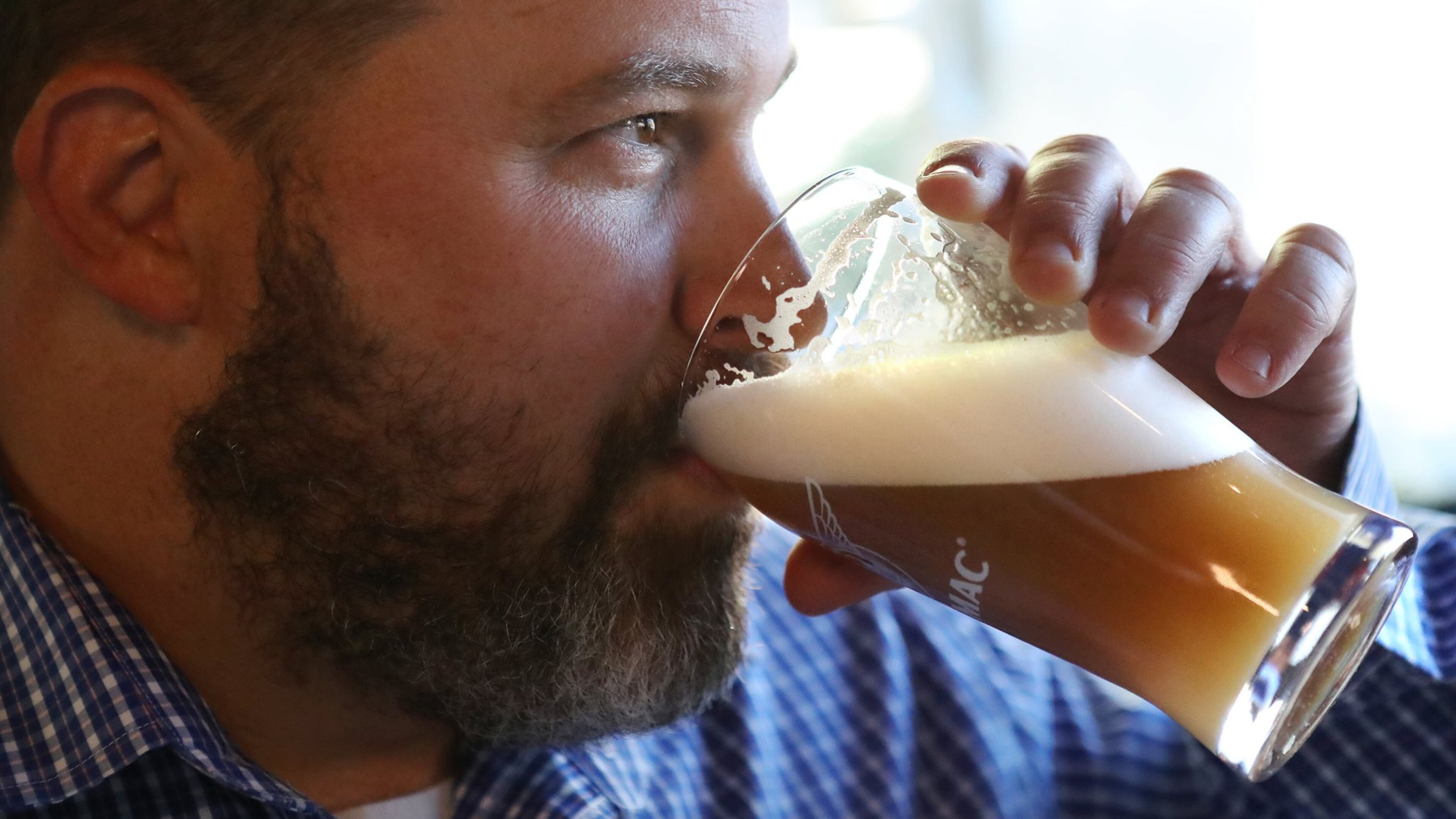 Rep. Kasey Carpenter samples his Space Force IPA, a teakwood-colored beer with citrus overtones. It was meant to mimic the Five Killer Citrus IPA that he produces at his Cherokee brewpub in Dalton. Curtis Compton/ccompton@ajc.com