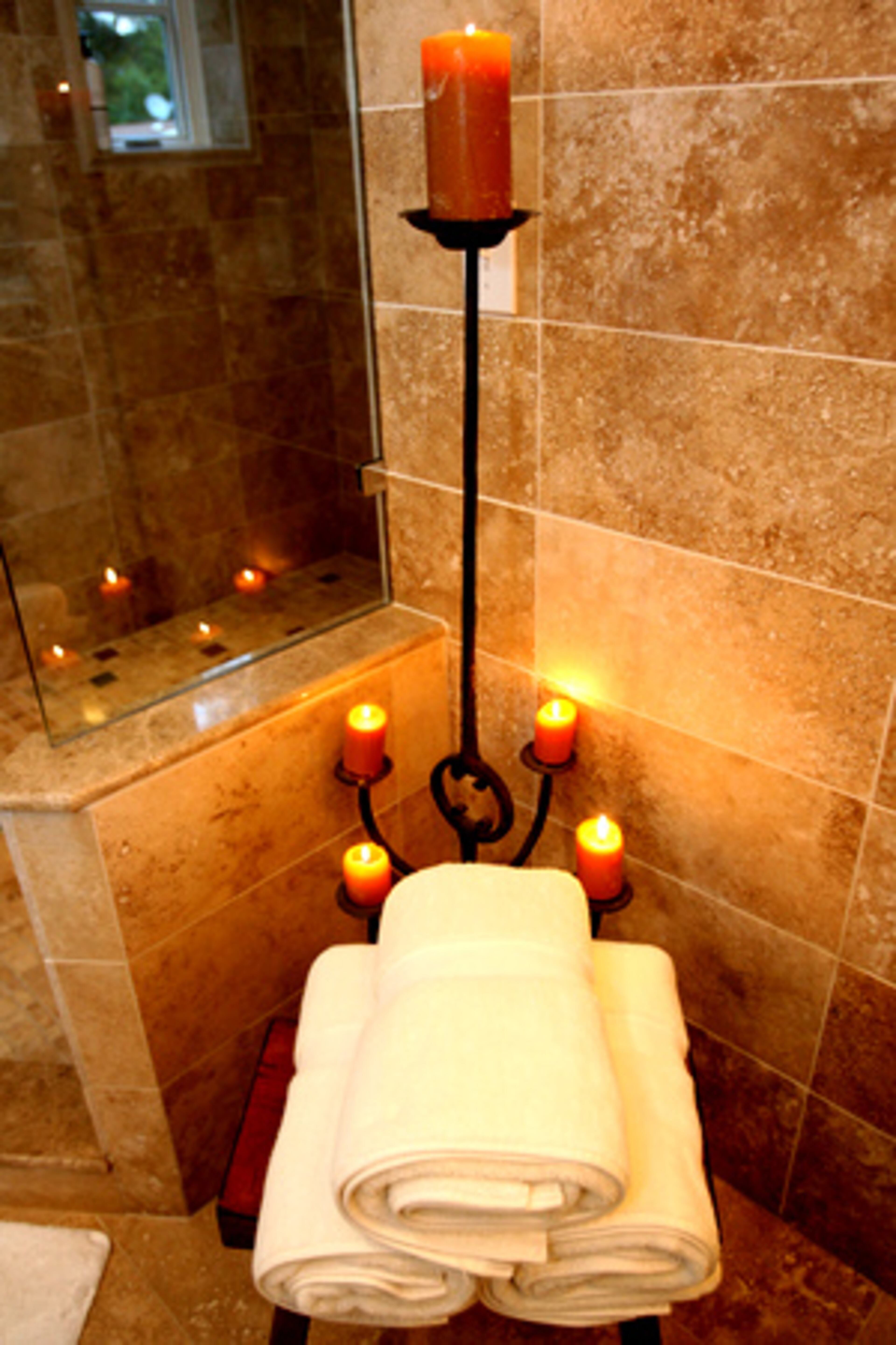 The tiles in the master bath are made of marble and travertine.