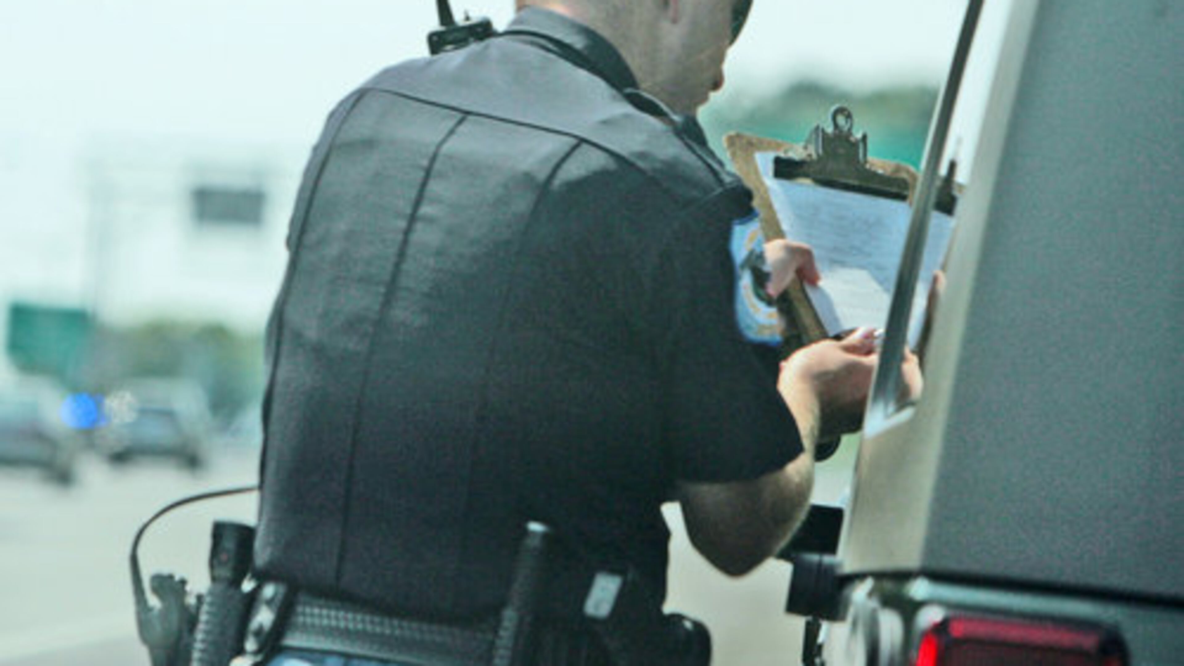 Cobb Police Officer Pete Jones tracked this individual going 78 mph, and is giving him his ticket to sign.