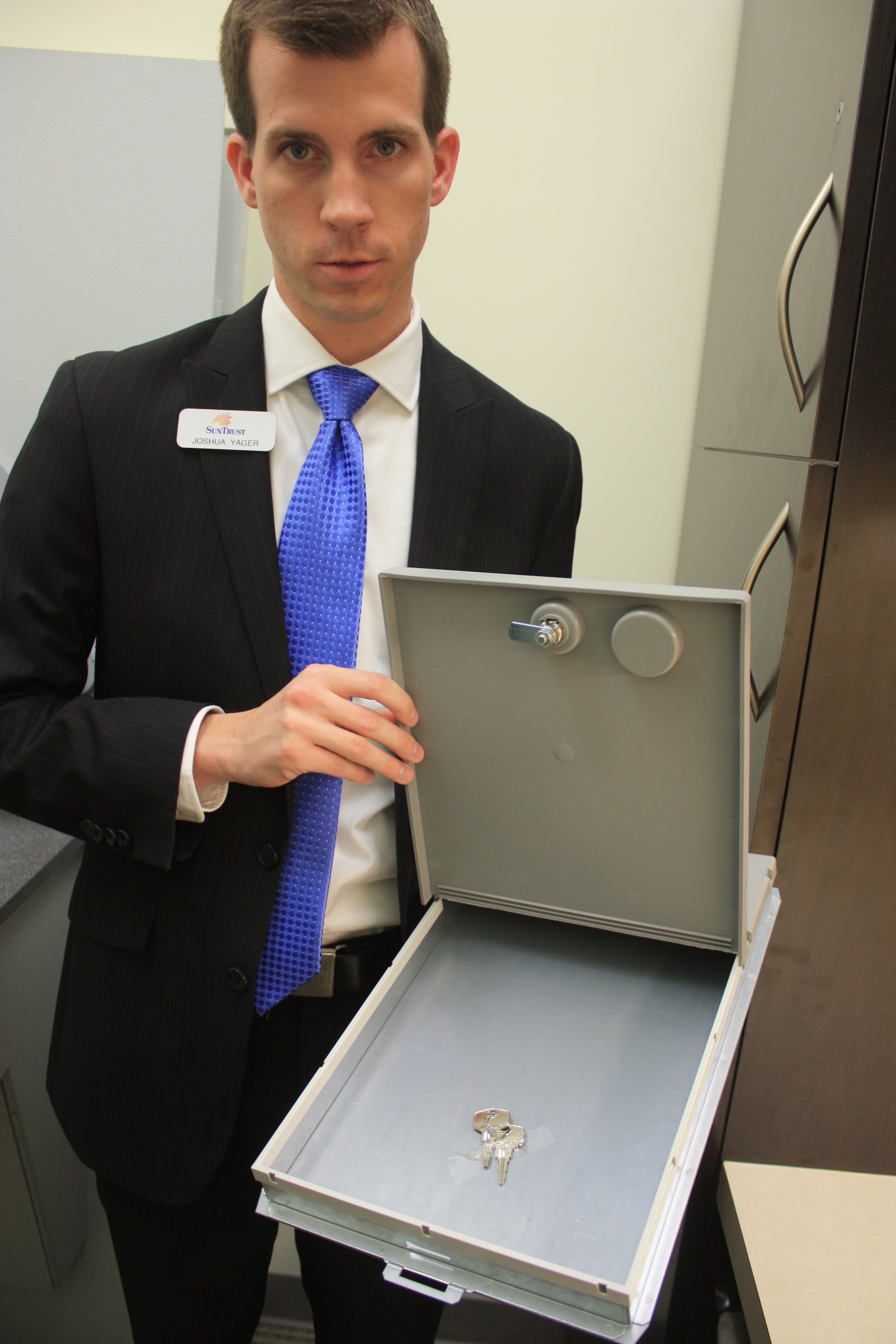 Joshua Yager, a SunTrust branch employee, shows off the system. The safe deposit boxes normally can't be removed from the machine, but here's what one looks like.
