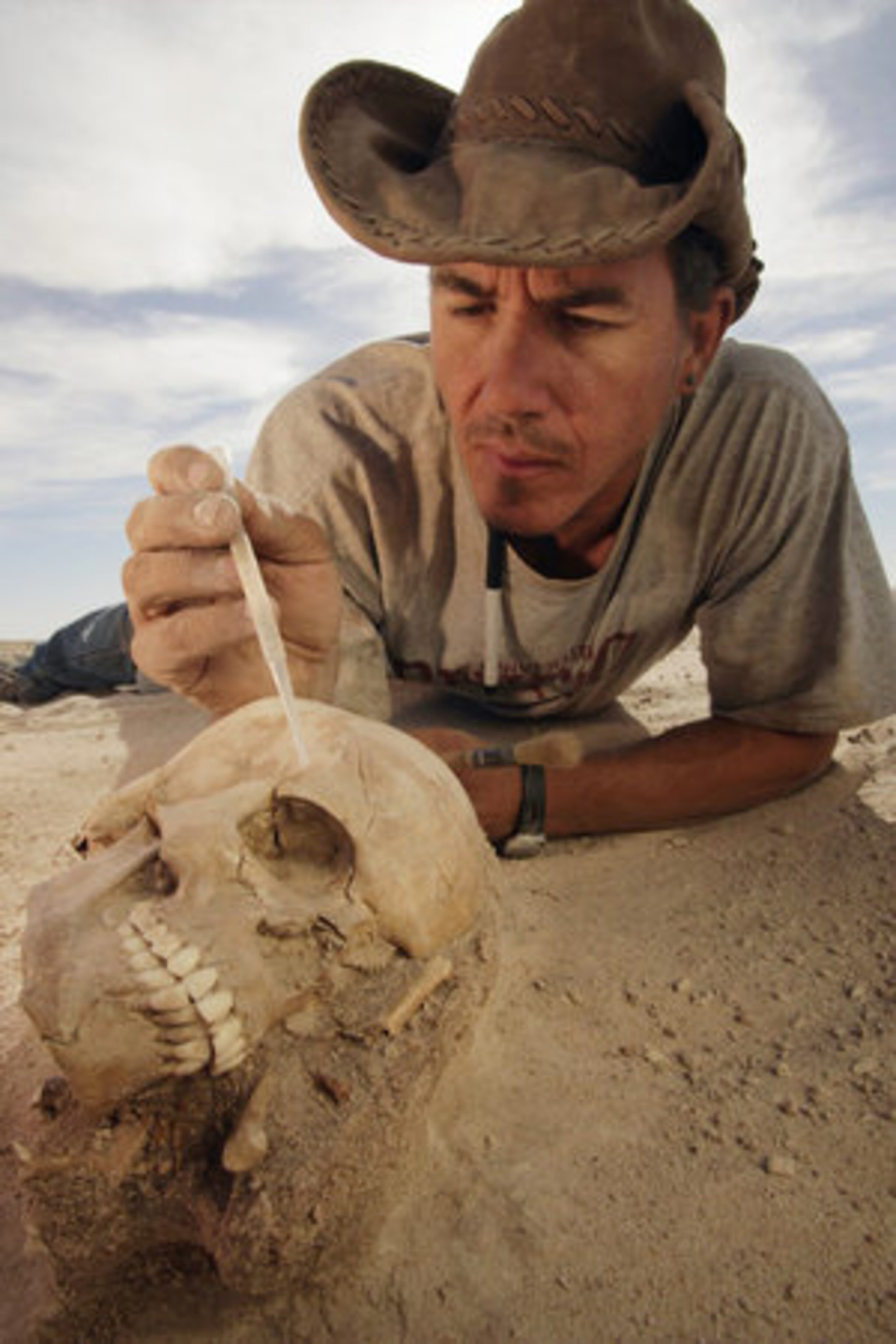 Paleontologist Paul Sereno of the University of Chicago stabilizes the nearly perfectly preserved skull of a Tenerian woman during excavation at the archaeological site of Gobero in Niger. Predating the Egyptian pyramids, the site's human record provides evidence of two distinct populations that lived in a green Sahara, separated in time by more than 1,000 years.