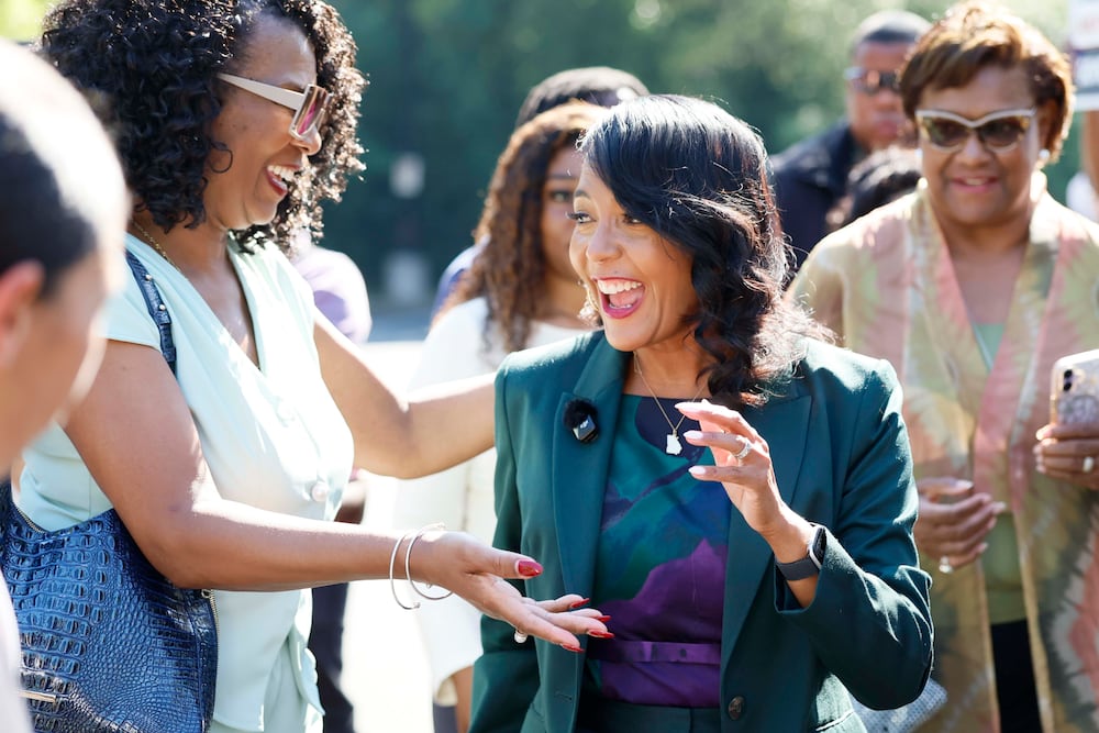 Democratic nominee for governor Keisha Lance Bottoms, center, is greeted by State Rep. Debra Bazemore, D-South Fulton, upon arriving at the City of South Fulton Southwest Arts Center to cast her ballot during early voting this month. (Miguel Martinez/AJC)