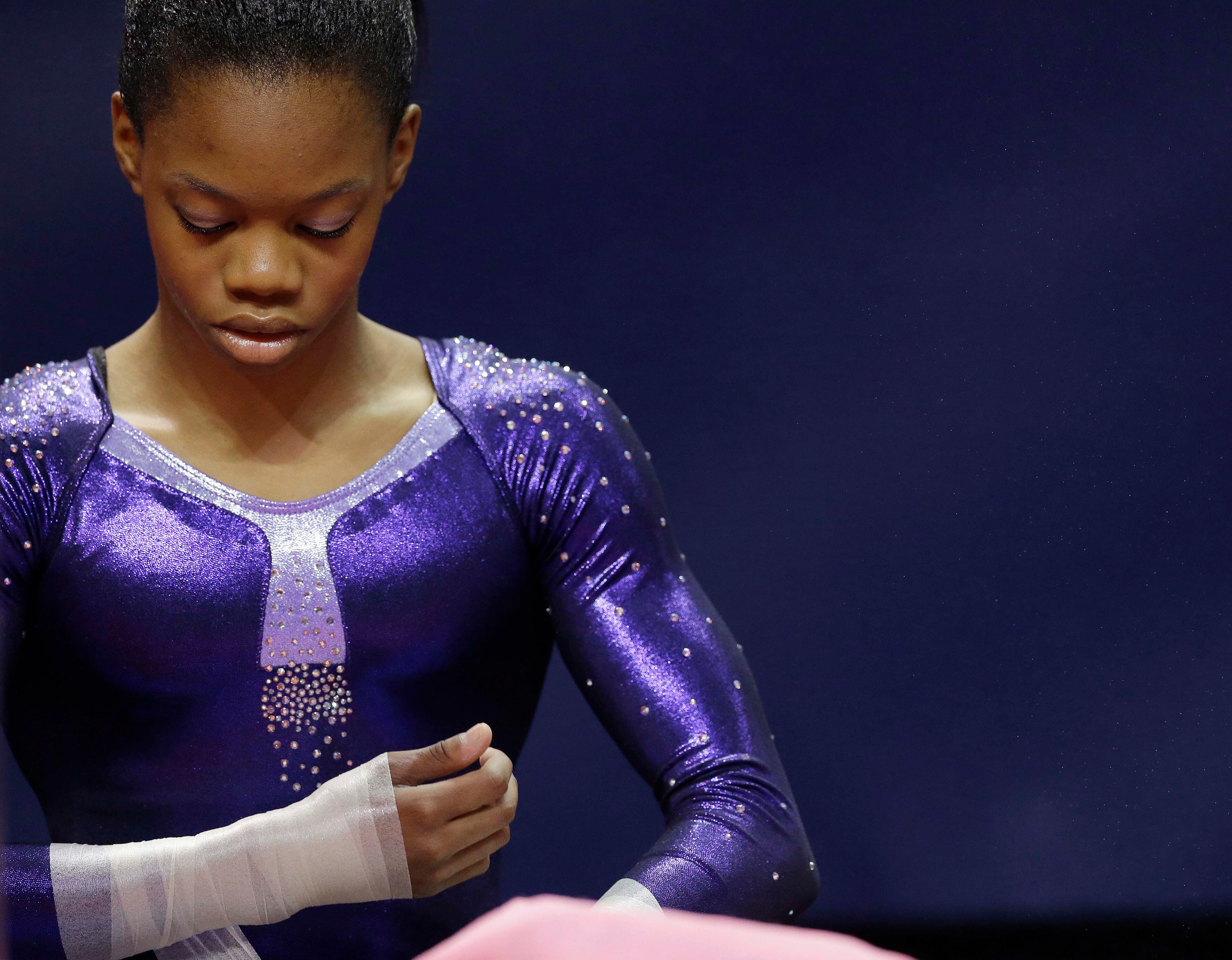 Kennedy Baker wraps her wrists before warming up for the final round of the women's Olympic gymnastics trials, Sunday, July 1, 2012, in San Jose, Calif. (AP Photo/Gregory Bull)