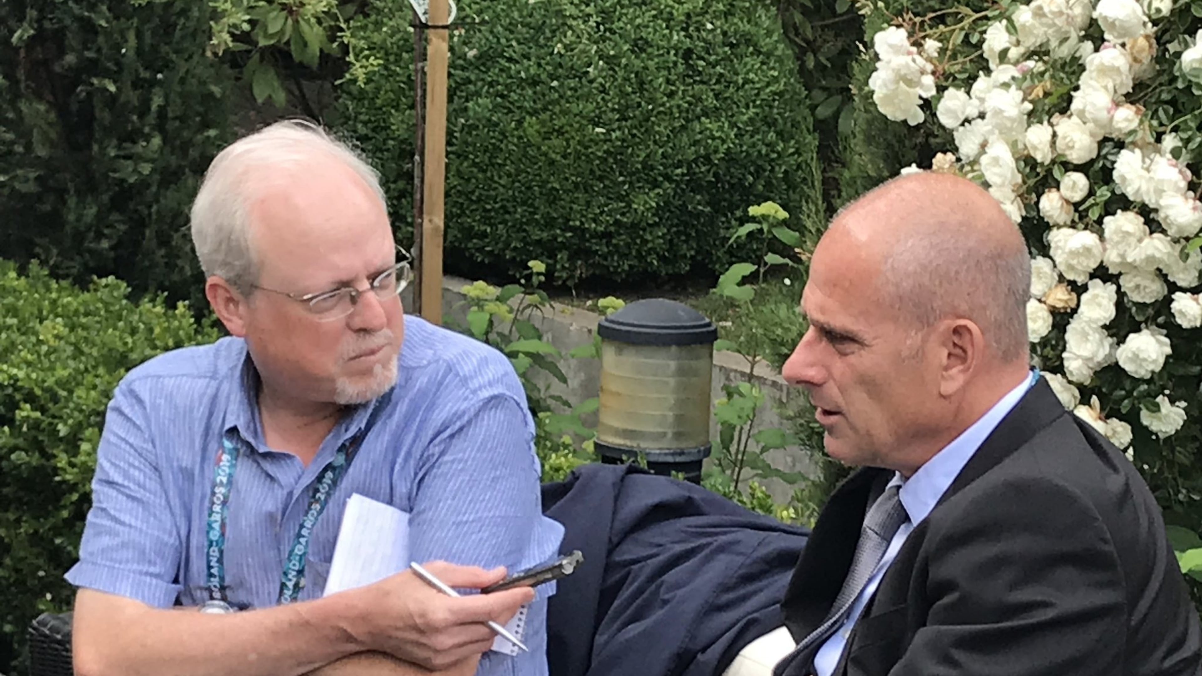 Howard Fendrich, left, Associated Press national sports writer, interviews former French tennis player Guy Forget at the 2019 French Open tennis tournament in Paris. (AP Photo/Andrew Dampf)