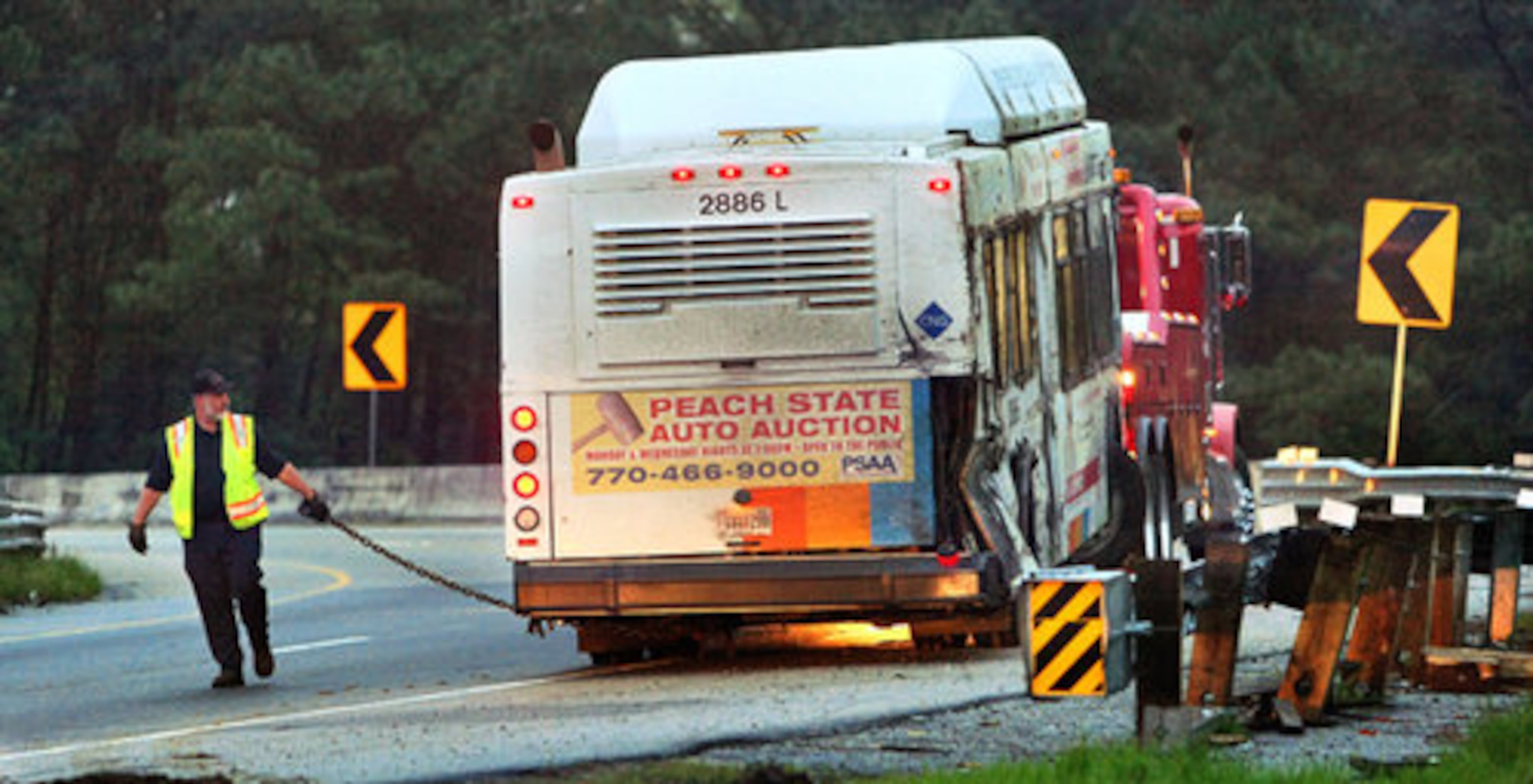A driver readies the bus for towing.