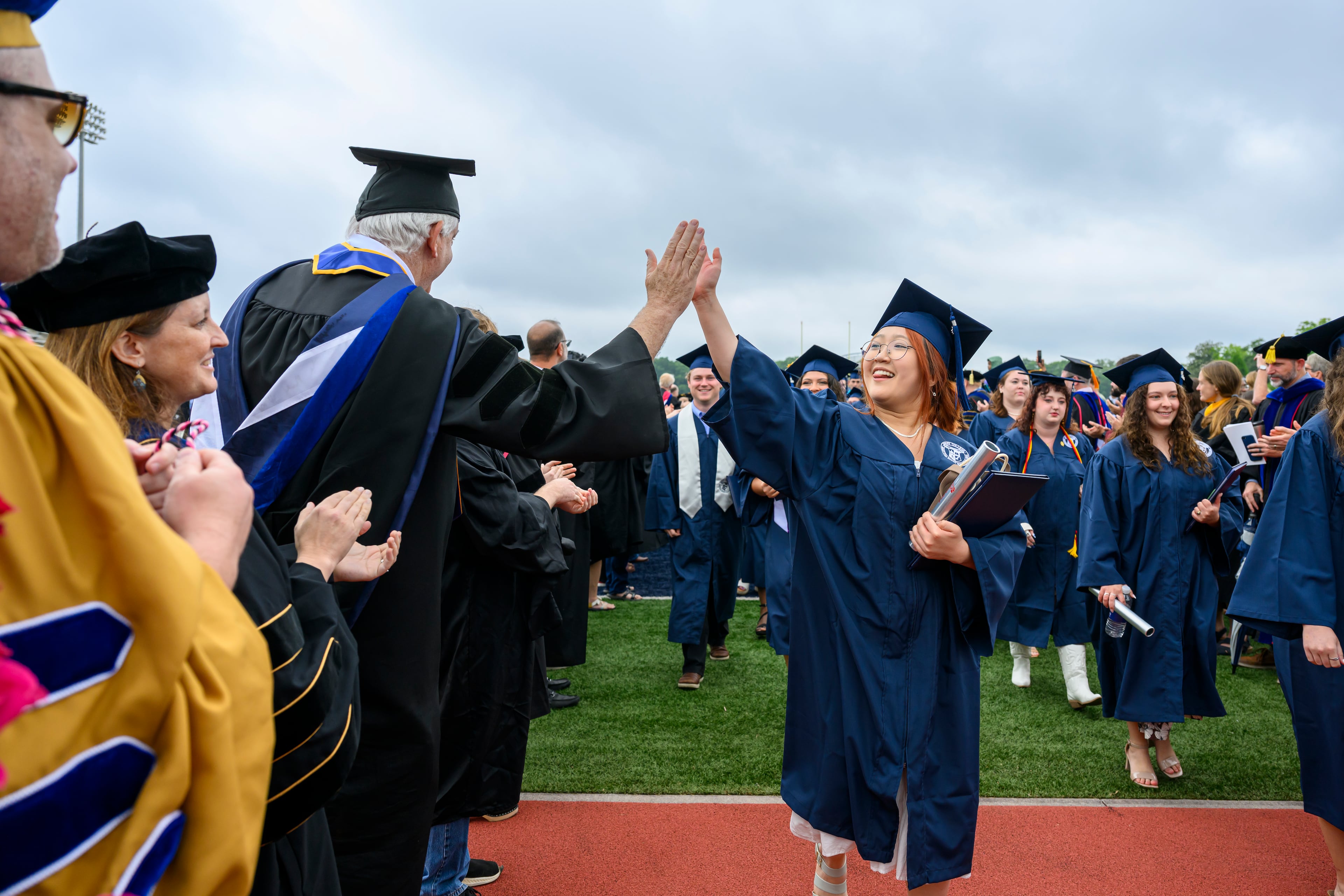 Berry College graduate Hannah Hwang is congratulated by John Grout, department chair of management and entrepreneurship, during commencement Saturday, May 9, 2026. The nationally recognized Georgia college is located on a campus encompassing more than 27,000 acres in Rome, Ga. (Brant Sanderlin/Berry College)