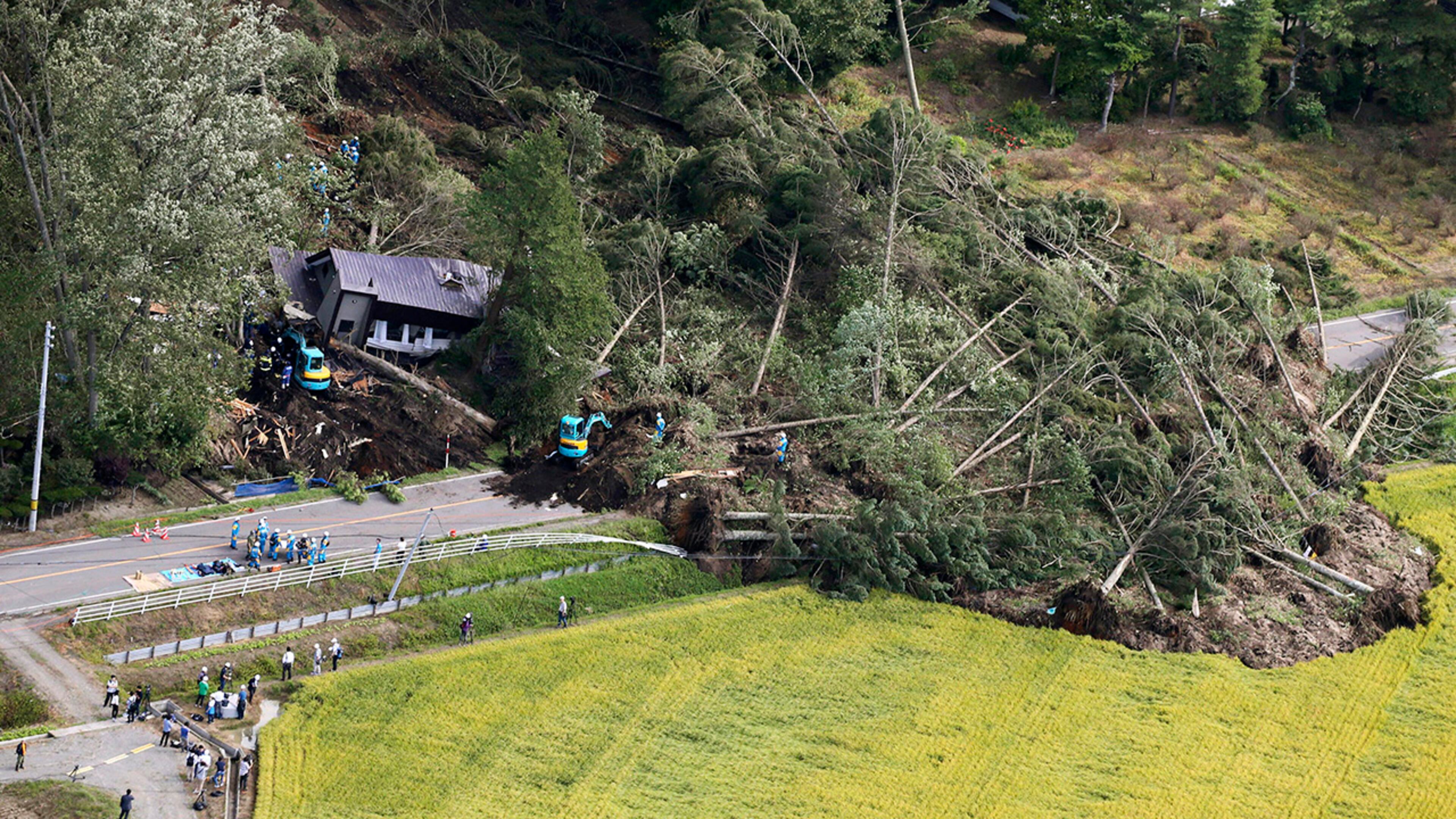 Police search missing persons at the site of a landslide after an earthquake in Atsuma town, Hokkaido, northern Japan, Thursday, Sept. 6, 2018. A powerful earthquake rocked Japanâs northernmost main island of Hokkaido early Thursday, triggering landslides that crushed homes, knocking out power across the island, and forcing a nuclear power plant to switch to a backup generator. (Kyodo News via AP)