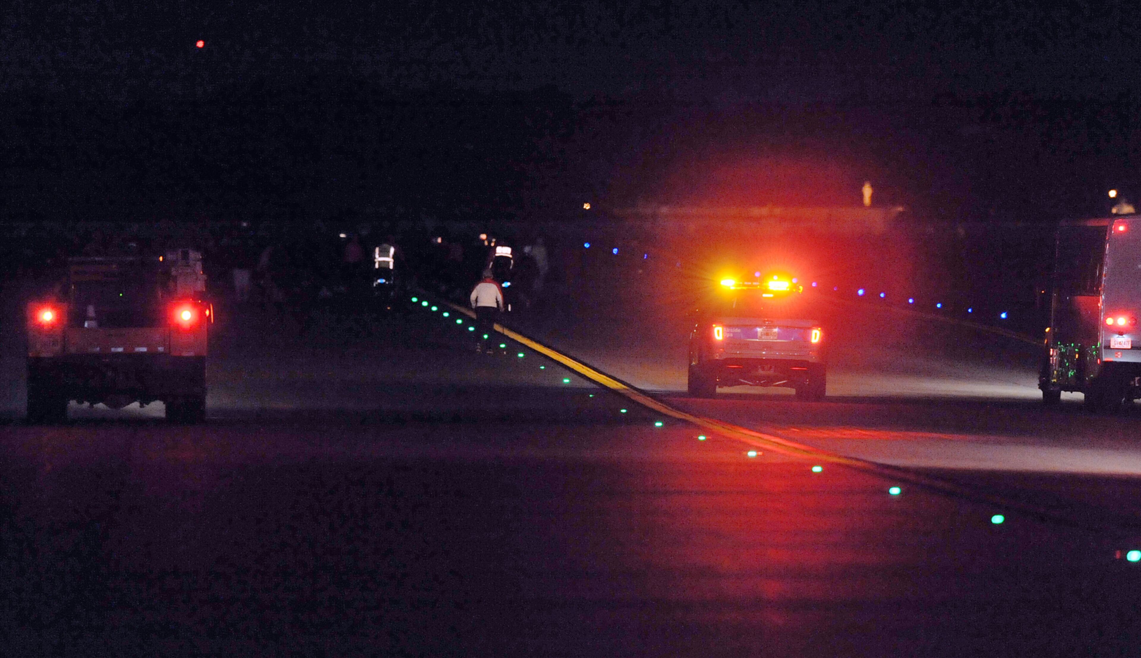 OCTOBER 17, 2015 ATLANTA Airport operations vehicles trail there runners as they recede into the darkness along the taxiway. Mayor Kasim Reed and United Way President Milton Little joined more than 2,000 runners at the Mayor’s Inaugural 5K on the 5th Runway at the world’s busiest airport Saturday, October 17, 2015. Airport officials shut down the 5th runway (Runway 10/28) until 8:15 am so runners and walkers could exit the course. All proceeds from the event will benefit United Way of Greater Atlanta. Major sponsors of The Mayor’s Inaugural 5K on the 5th Runway include Delta Air Lines, The Coca-Cola Company, Enterprise Rental Car, Georgia International Convention Center, MARTA, and Publix. Over $123,000 was raised, said airport spokesman Reese McCranie. The race's overall winner was Andrew Murfee, 15, a Woodward Academy student. KENT D. JOHNSON/KDJOHNSON@AJC.COM