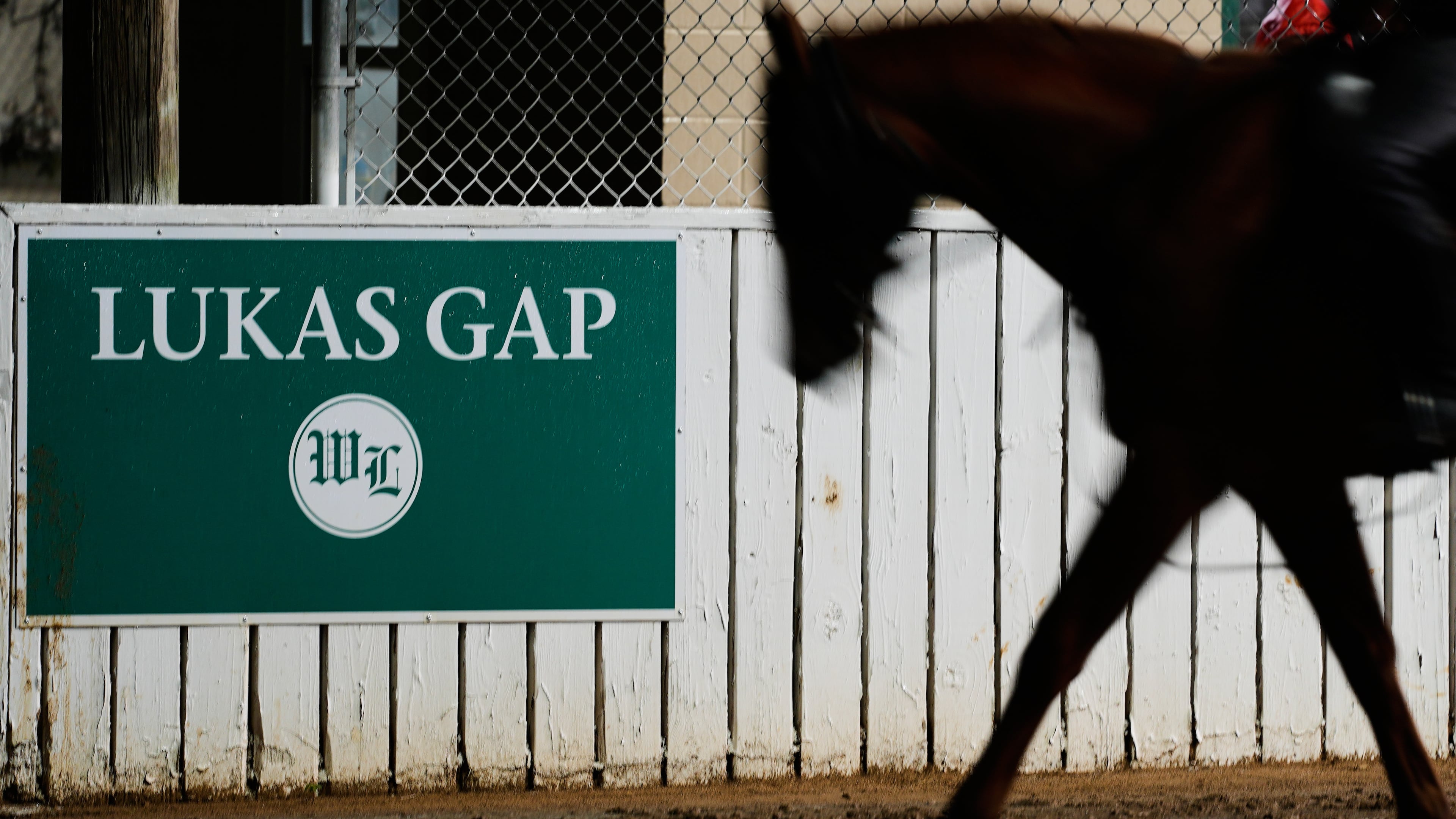 A horse comes off the track through the Lukas Gap gate, named in honor of deceased Hall of Fame trainer D. Wayne Lukas, Wednesday, April 29, 2026, at Churchill Downs in Louisville, Ky. (AP Photo/Charlie Riedel)