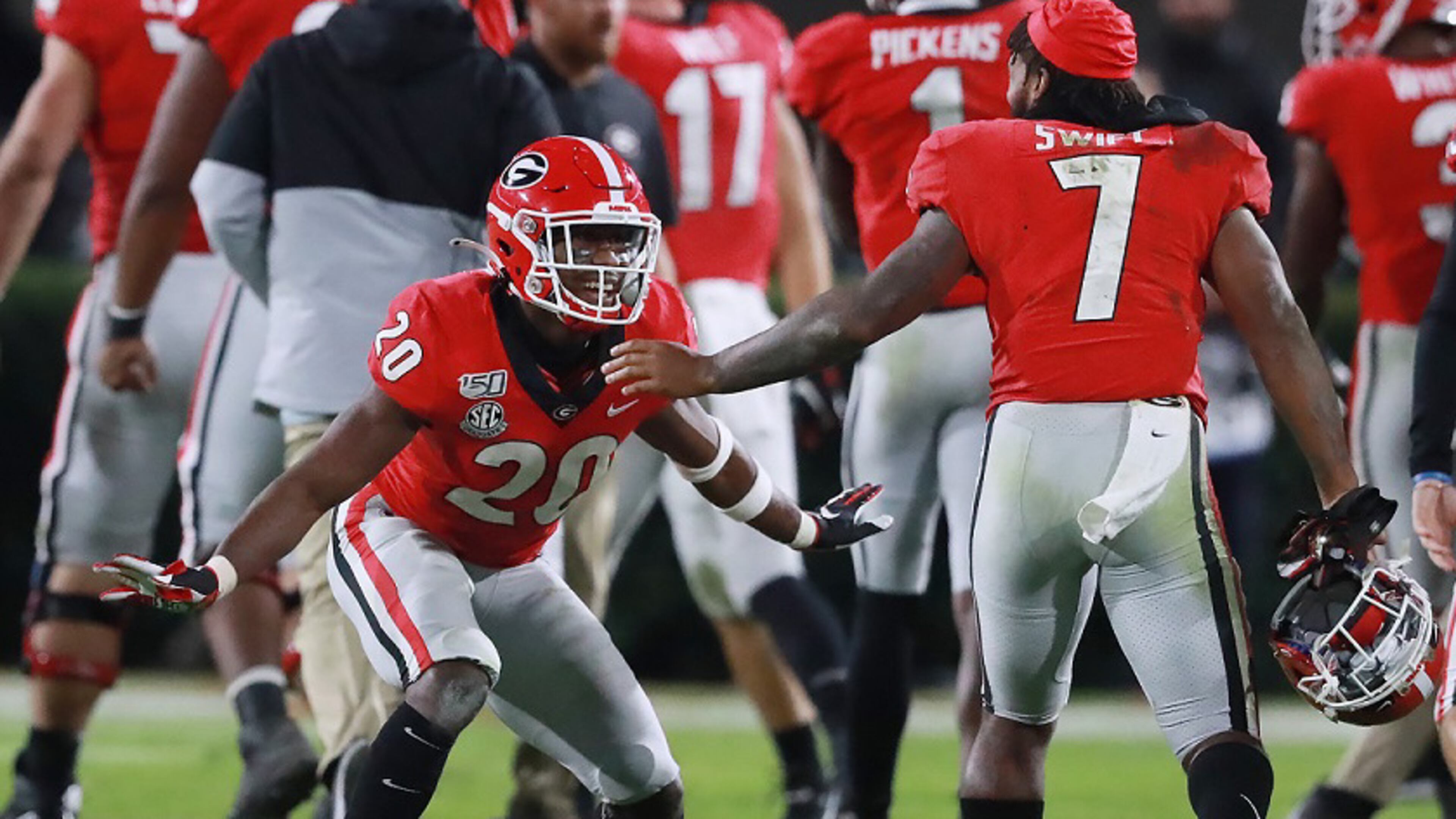 Georgia defensive back J.R. Reed (left) celebrates stopping Missouri on fourth down with tailback D'Andre Swift (right) to take over on downs in the final minutes of the fourth quarter and preserve a 27-0 shutout over Missouri on Saturday, November 9, 2019, in Athens. Curtis Compton/ccompton@ajc.com