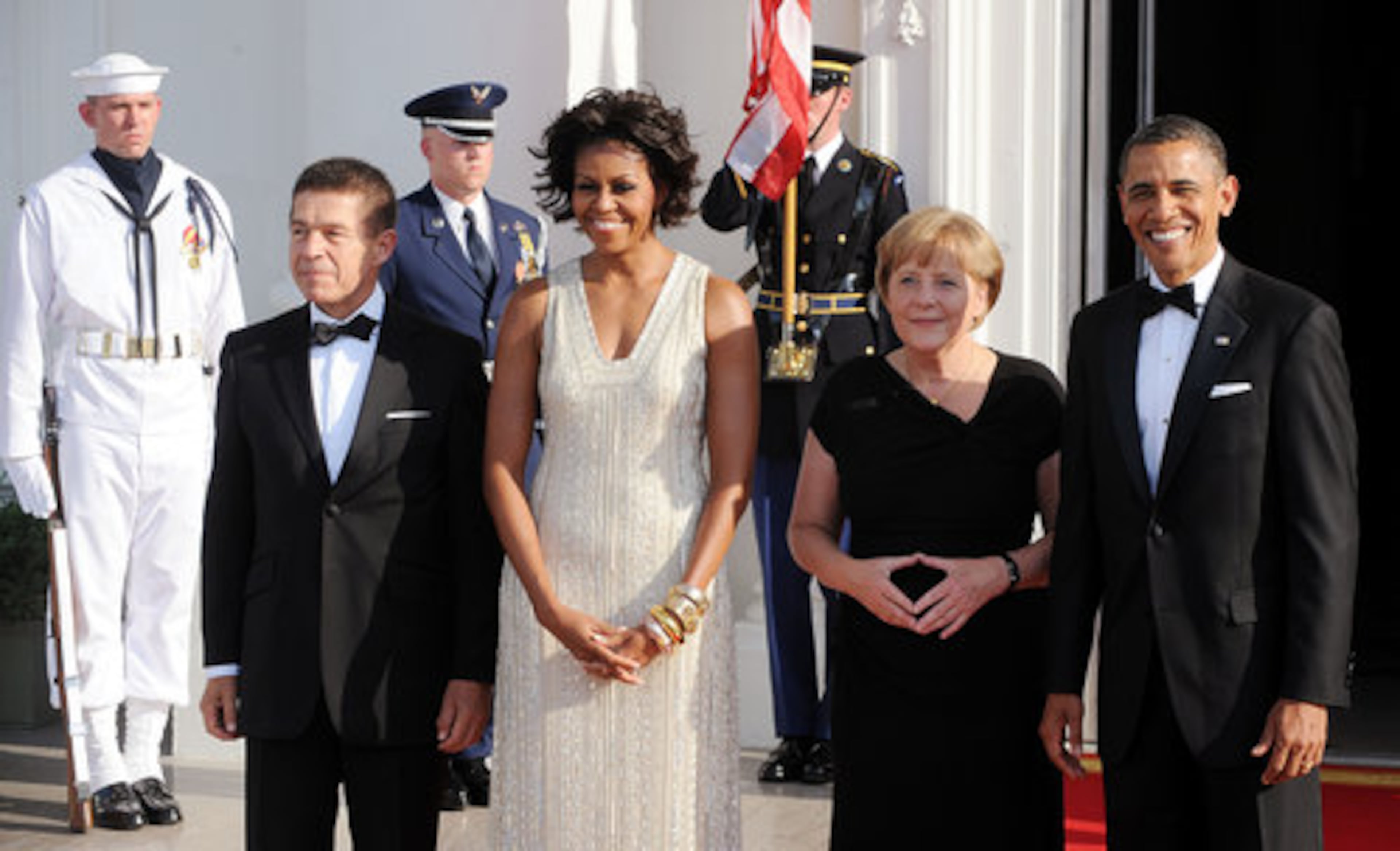 President Barack Obama and first lady Michelle Obama welcome German Chancellor Angela Merkel (second from right) and her husband Joachim Sauer (left) to the White House.(