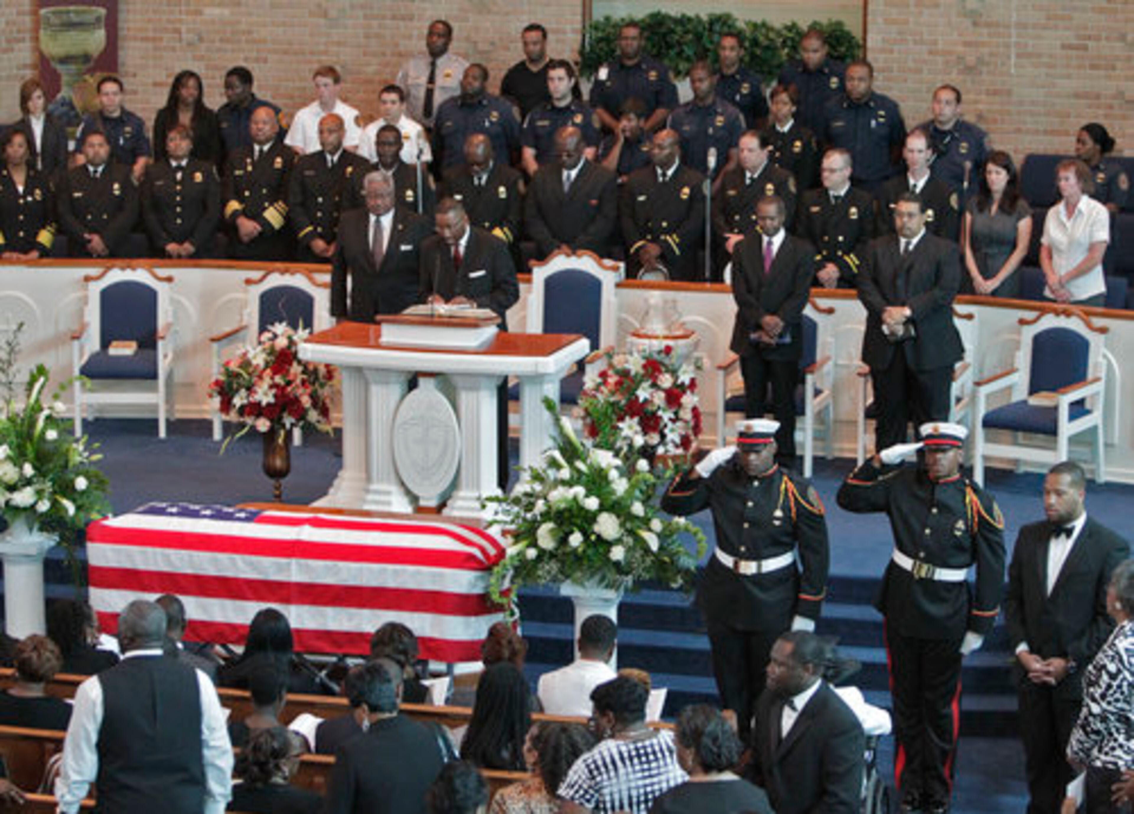 The funeral for firefighter Carl Blake, who died this week in a motorcycle accident, was held at Christian Fellowship Baptist Church in College Park. Here, an honor guard (right) salutes during the processional into the church.