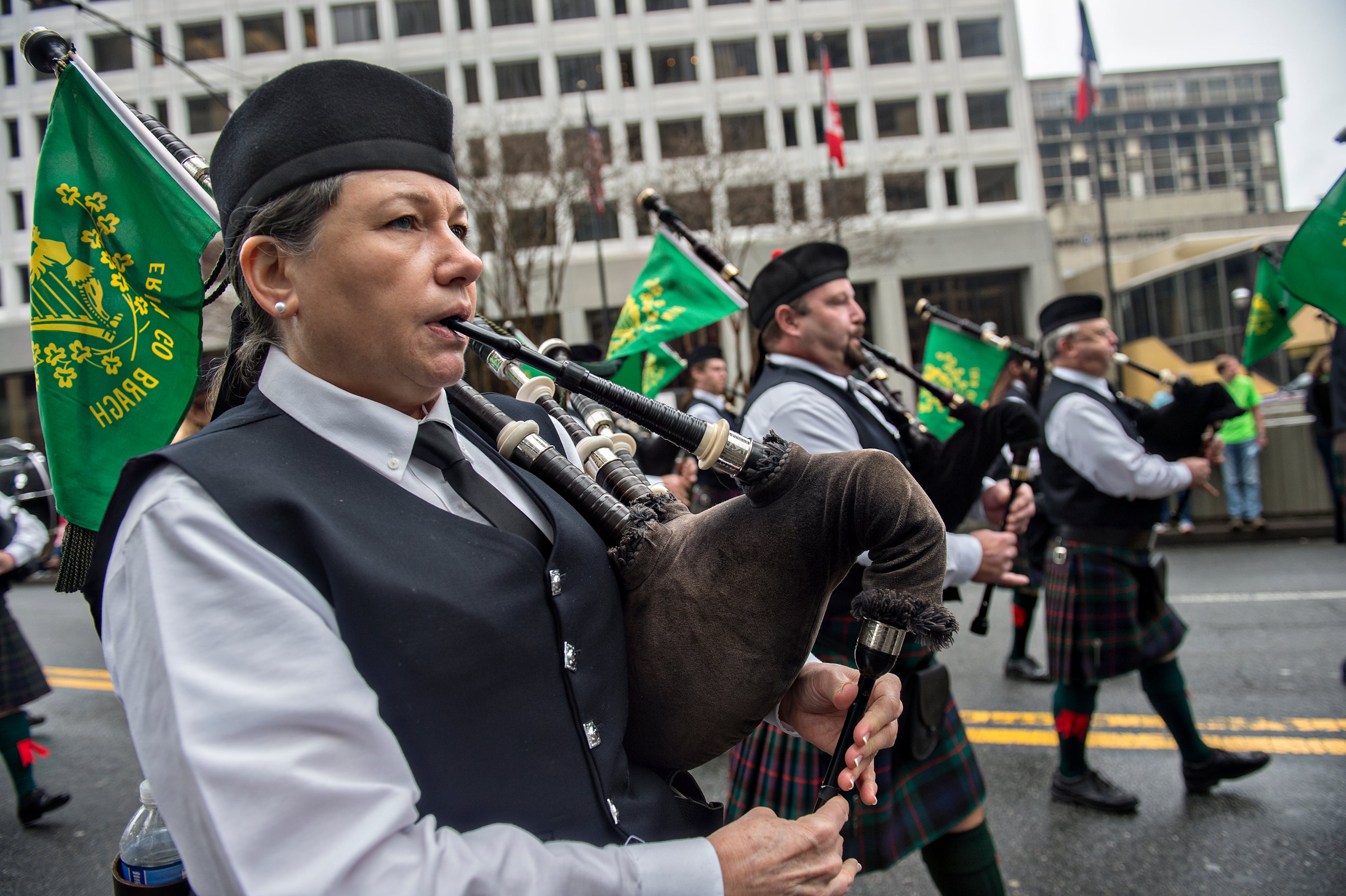 Janice Summers (left) plays the bagpipes as she marches down Peachtree Street during the 2015 Atlanta St. Patrick's Parade on Saturday, March 14, 2015. Thousands of people attend the parade which dates back to 1858. JONATHAN PHILLIPS / SPECIAL