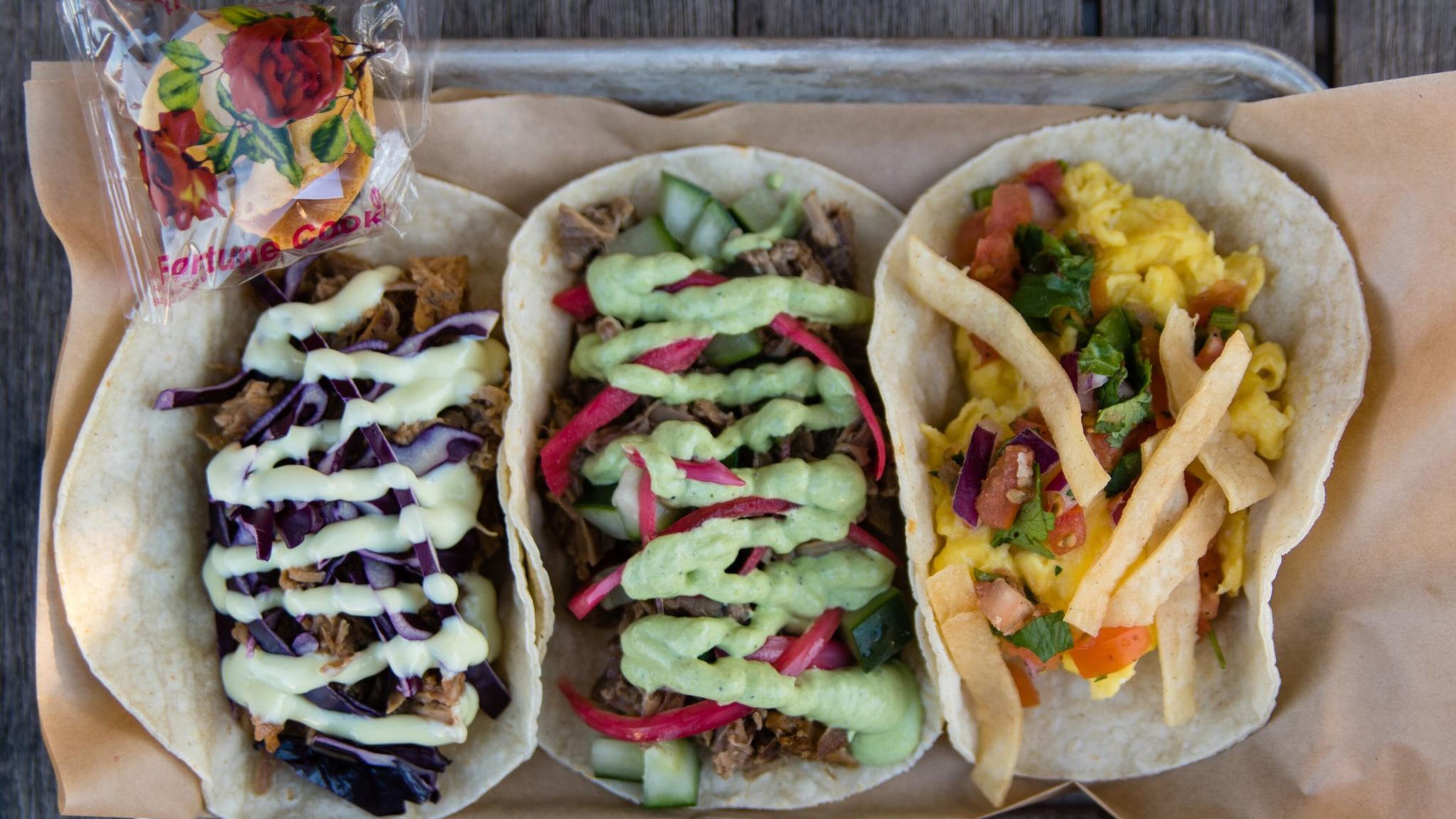 Three tacos from Strange Tacos in Lawrenceville (left to right): lamb, duck and migas. CONTRIBUTED BY HENRI HOLLIS