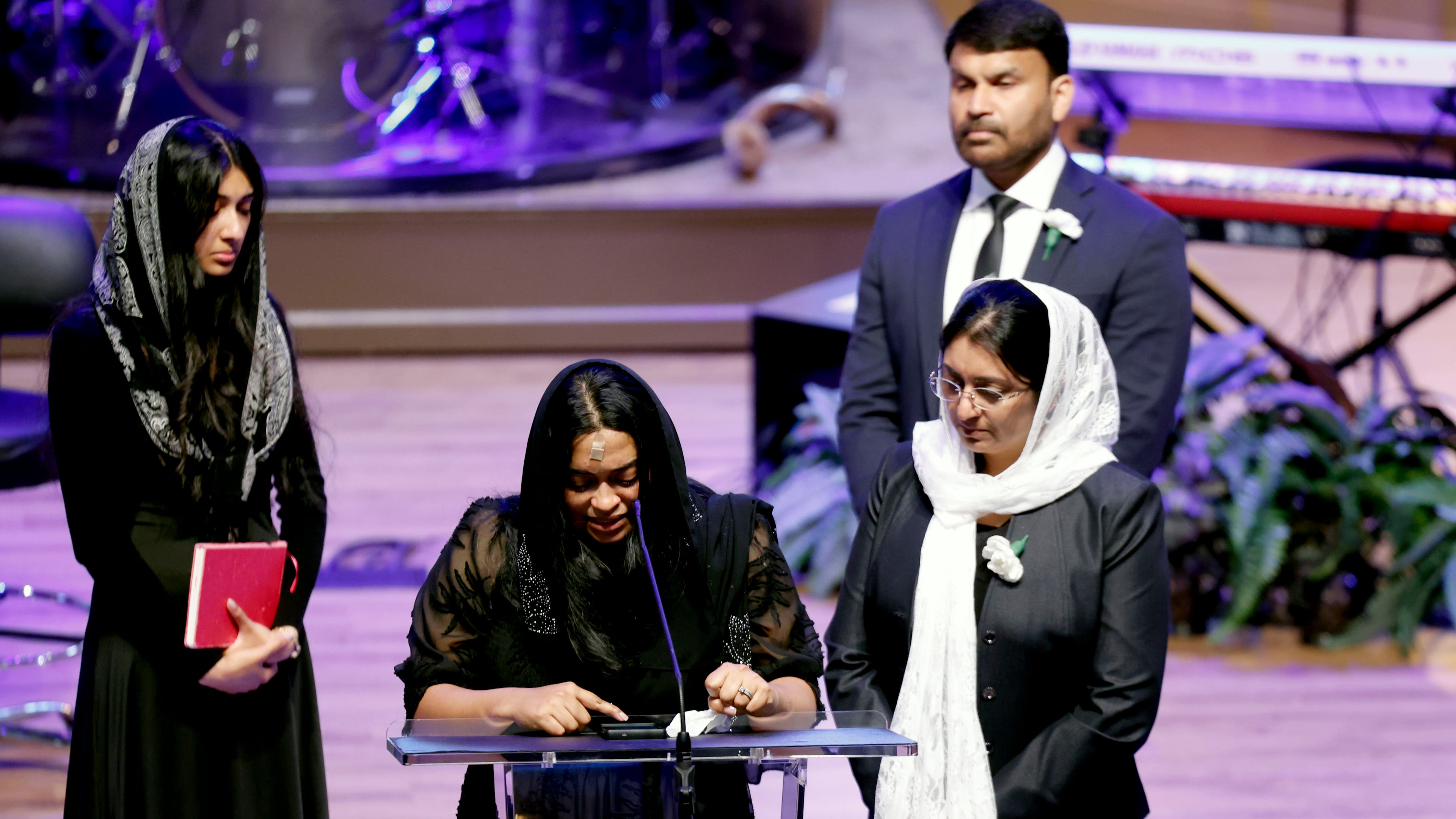 Jesni Sam speaks at her late husband's funeral on June 6, 2026, at Praise Community Church in Lawrenceville. She and Dave Fiji boarded a helicopter late May 29 after their Dawson County wedding, and the aircraft crashed not long after, killing Fiji. (Akili-Casundria Ramsess for the AJC)
