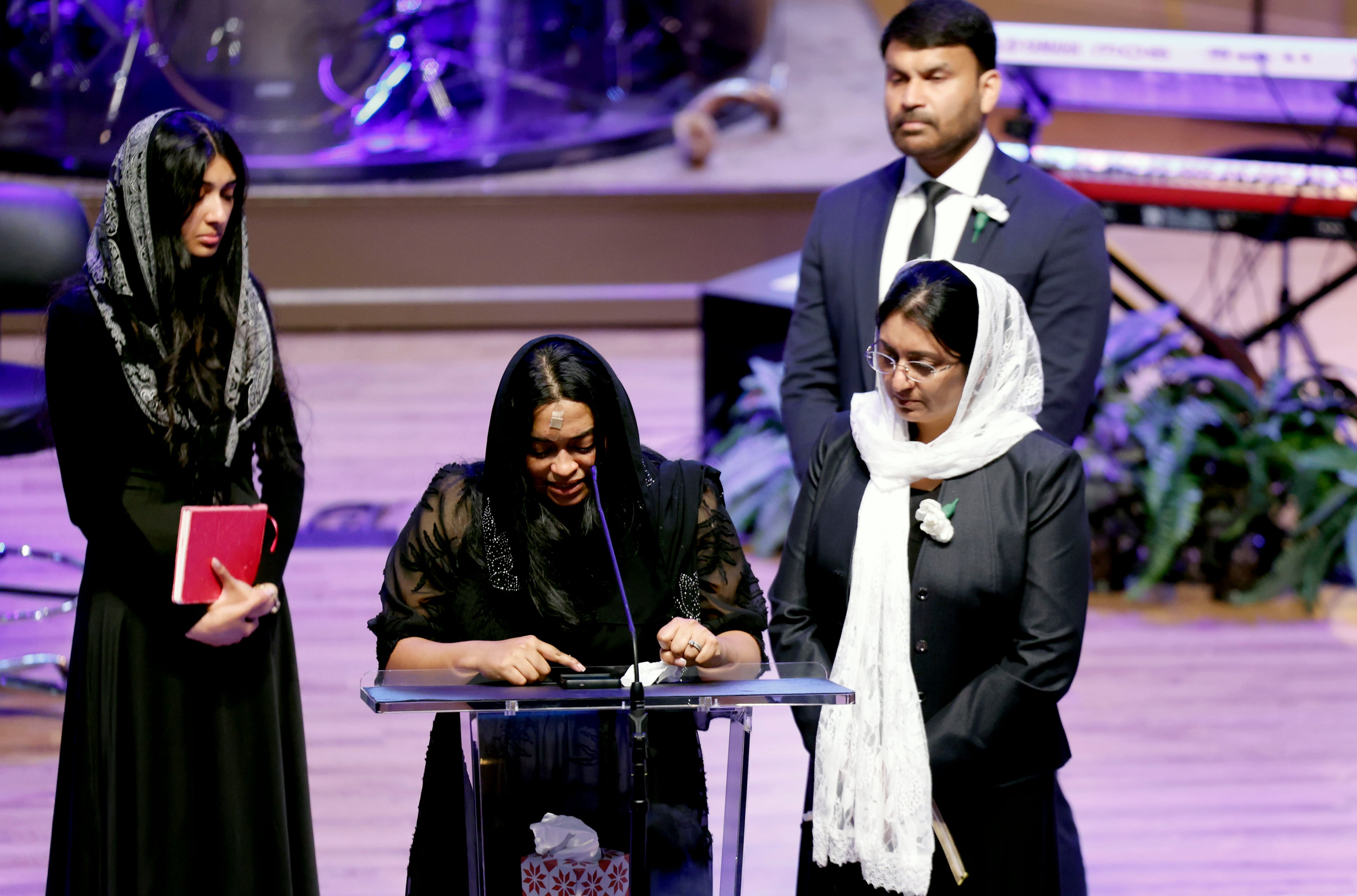 Jesni Sam speaks at her late husband's funeral on June 6, 2026, at Praise Community Church in Lawrenceville. She and Dave Fiji boarded a helicopter late May 29 after their Dawson County wedding, and the aircraft crashed not long after, killing Fiji. (Akili-Casundria Ramsess for the AJC)