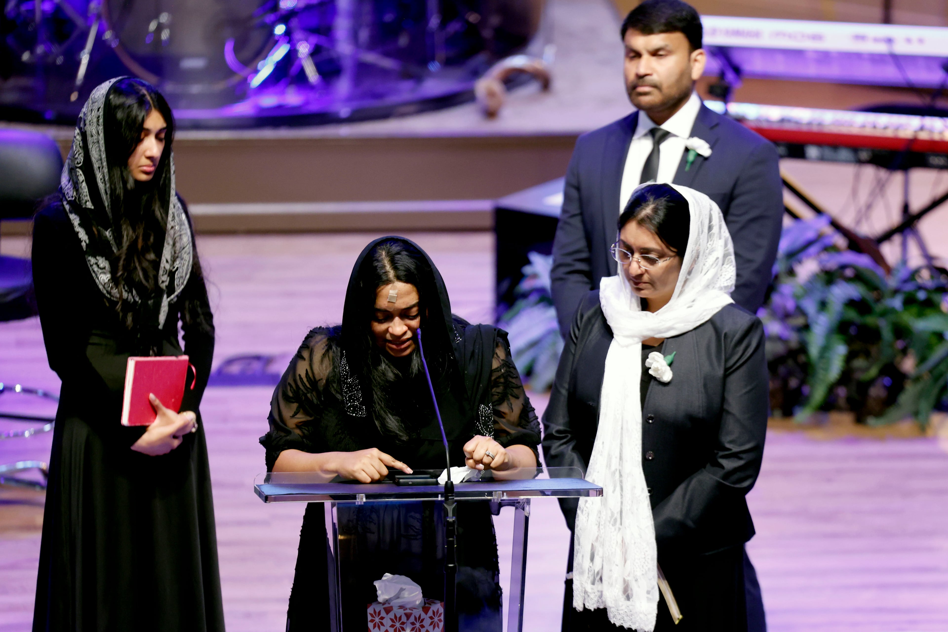 Jesni Sam speaks at her late husband's funeral on June 6, 2026, at Praise Community Church in Lawrenceville. She and Dave Fiji boarded a helicopter late May 29 after their Dawson County wedding, and the aircraft crashed not long after, killing Fiji. (Akili-Casundria Ramsess for the AJC)