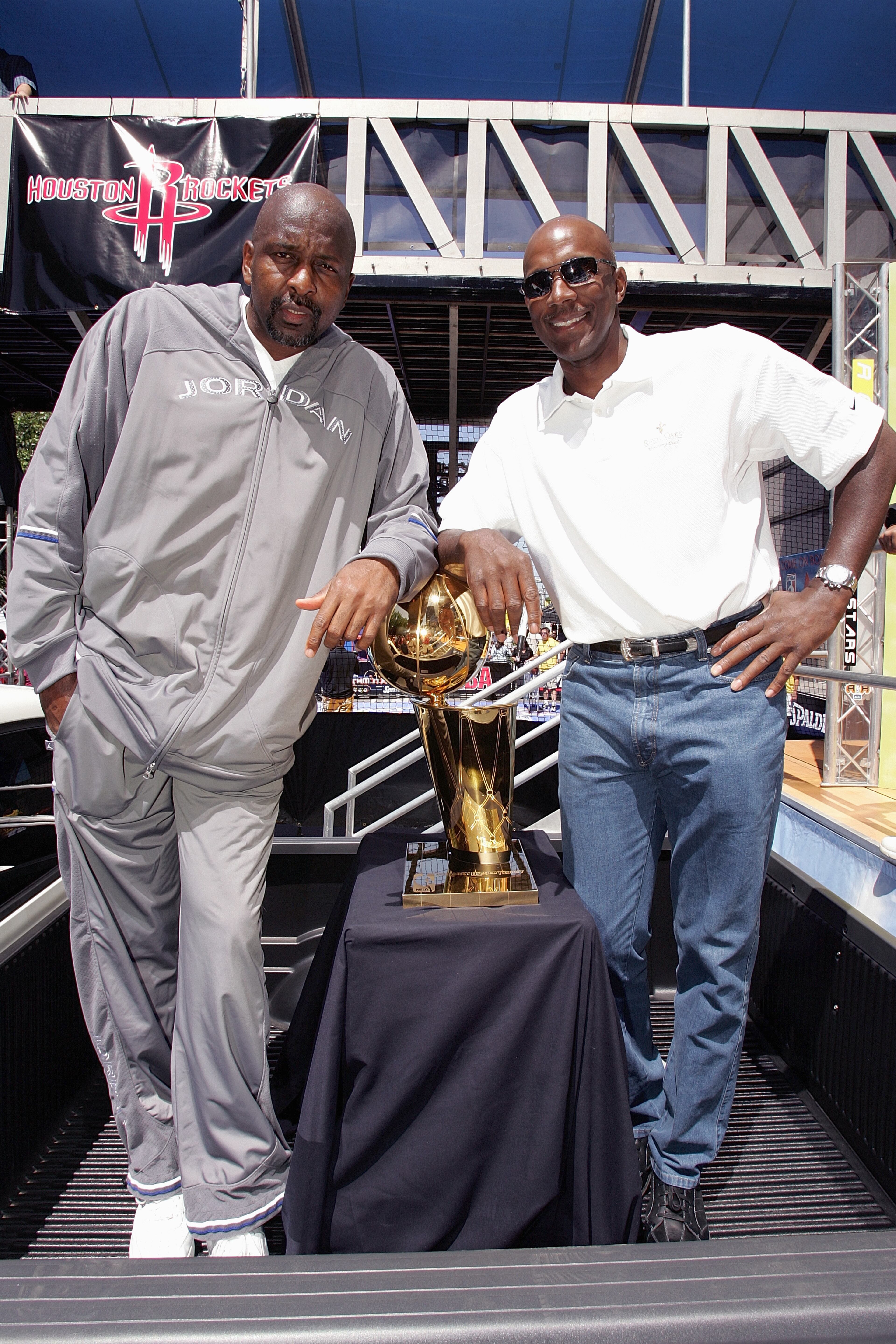 HOUSTON - APRIL 23: Former NBA players Moses Malone and Clyde Drexler pose with the Larry O'Brien NBA Championship Trophy at the NBA Rhythm 'n Rims tour on April 23, 2005 in Houston, Texas. NOTE TO USER: User expressly acknowledges and agrees that, by downloading and/or using this Photograph, user is consenting to the terms and conditions of the Getty Images License Agreement. Mandatory Copyright Notice: Copyright 2005 NBAE (Photo by Bill Baptist/NBAE via Getty Images)