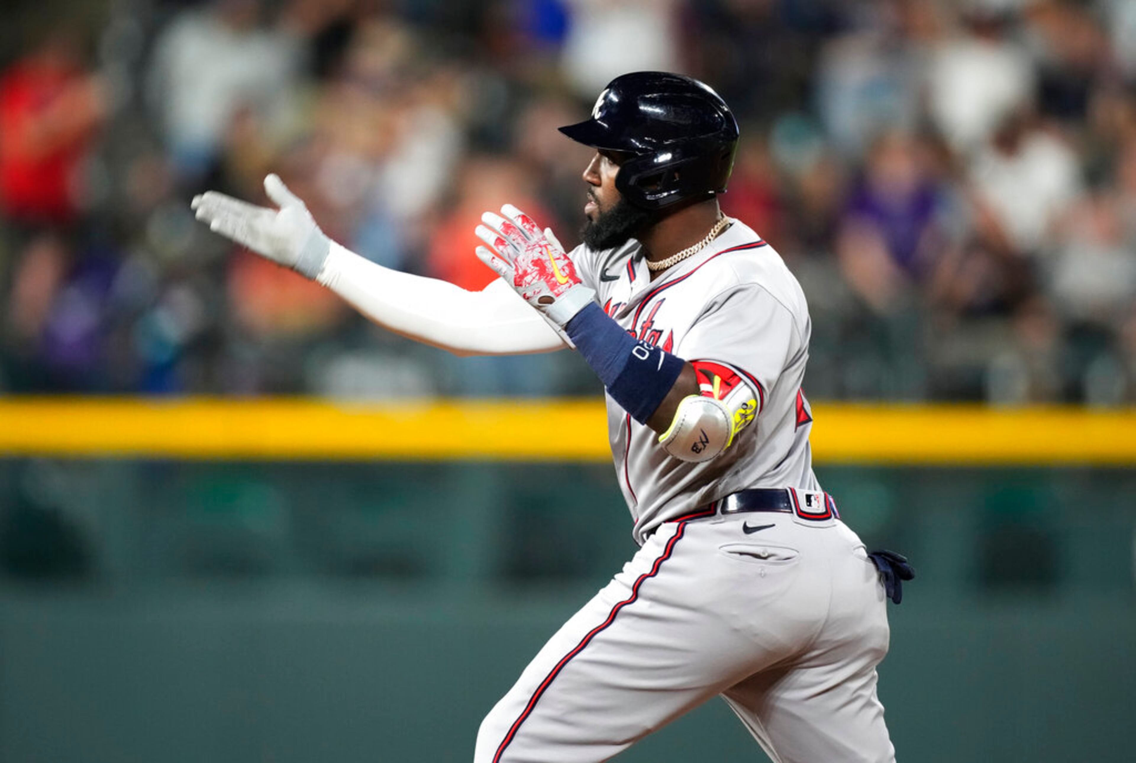 Atlanta Braves' Marcell Ozuna gestures after his RBI double off Colorado Rockies relief pitcher Jhoulys Chacin during the 11th inning of a baseball game Saturday, June 4, 2022, in Denver. (AP Photo/David Zalubowski)