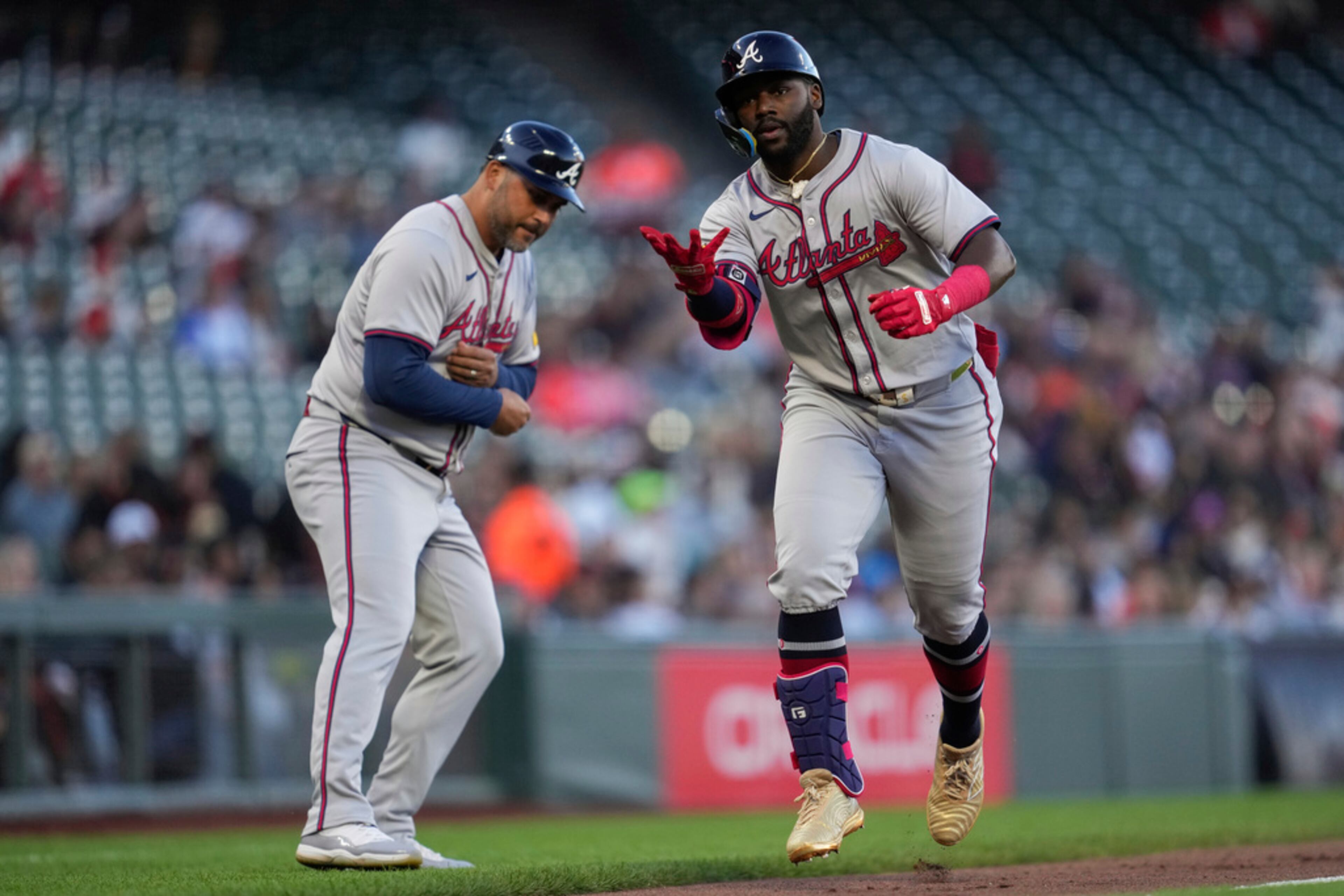Atlanta Braves' Michael Harris II, right, celebrates with third base coach Matt Tuiasosopo after hitting a grand slam against the San Francisco Giants during the first inning of a baseball game Wednesday, Aug. 14, 2024, in San Francisco. (AP Photo/Godofredo A. Vásquez)
