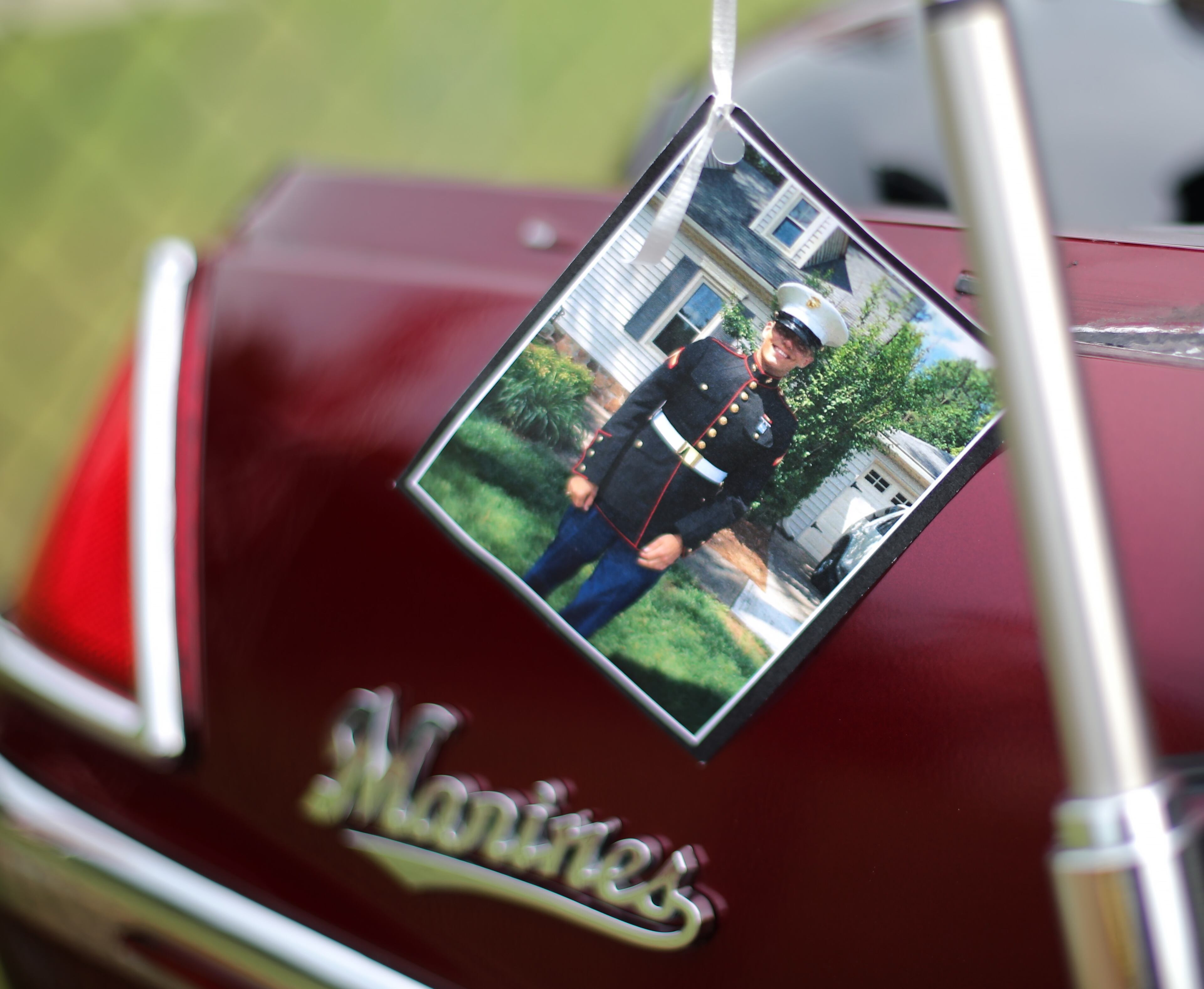 A photo of Skip Wells in uniform is displayed at a memorial service Tuesday evening July 21, 2015. at Sprayberry High School. Ben Gray / bgray@ajc.com