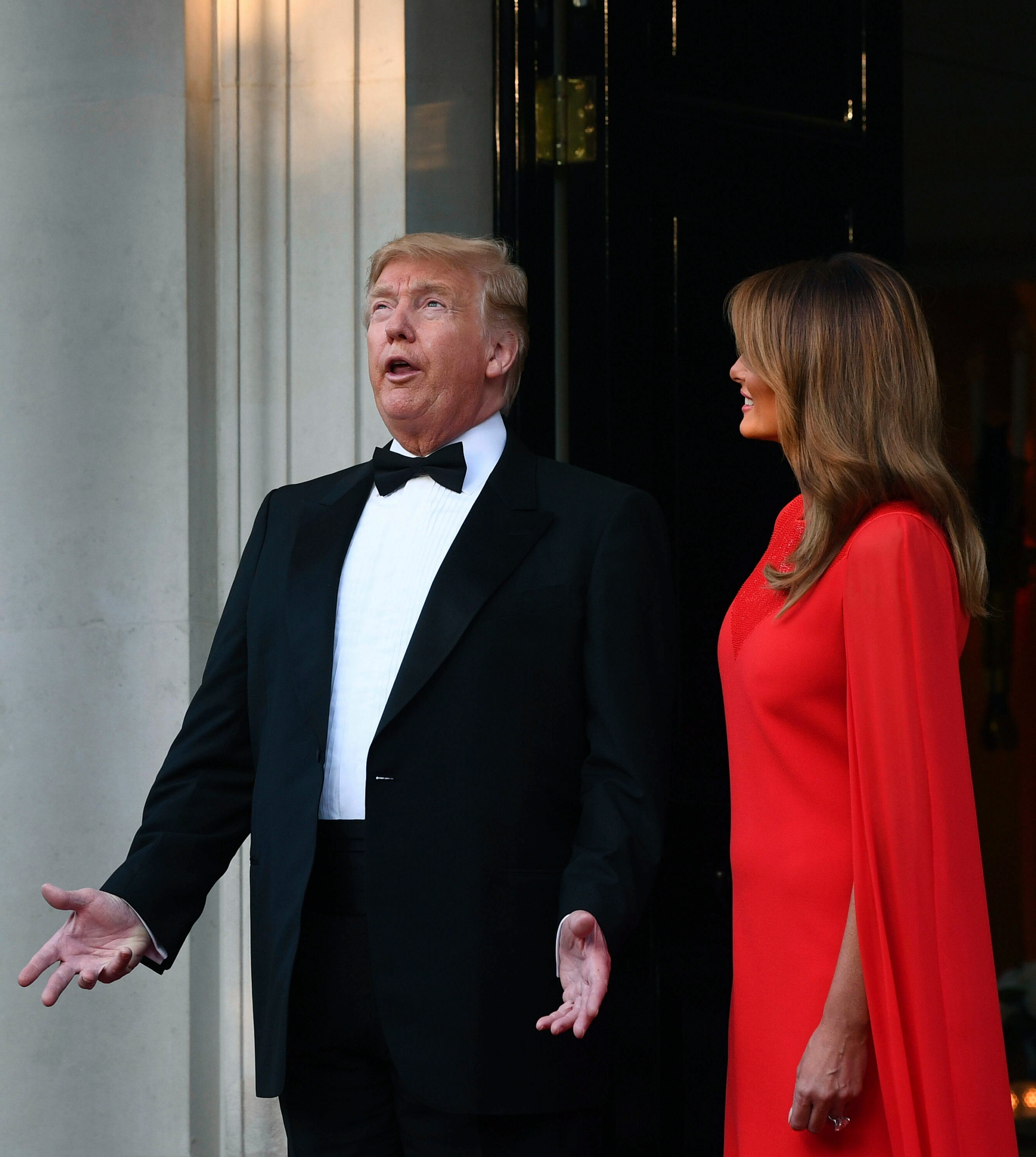 US President Donald Trump and first lady Melania Trump wait to greet Britain's Prince Charles and Camilla, the Duchess of Cornwall, outside Winfield House, the residence of the Ambassador of the United States of America to the UK, in Regent's Park, London, for the Return Dinner as part of his state visit to the UK, Tuesday June 4, 2019. (Victoria Jones/PA via AP)