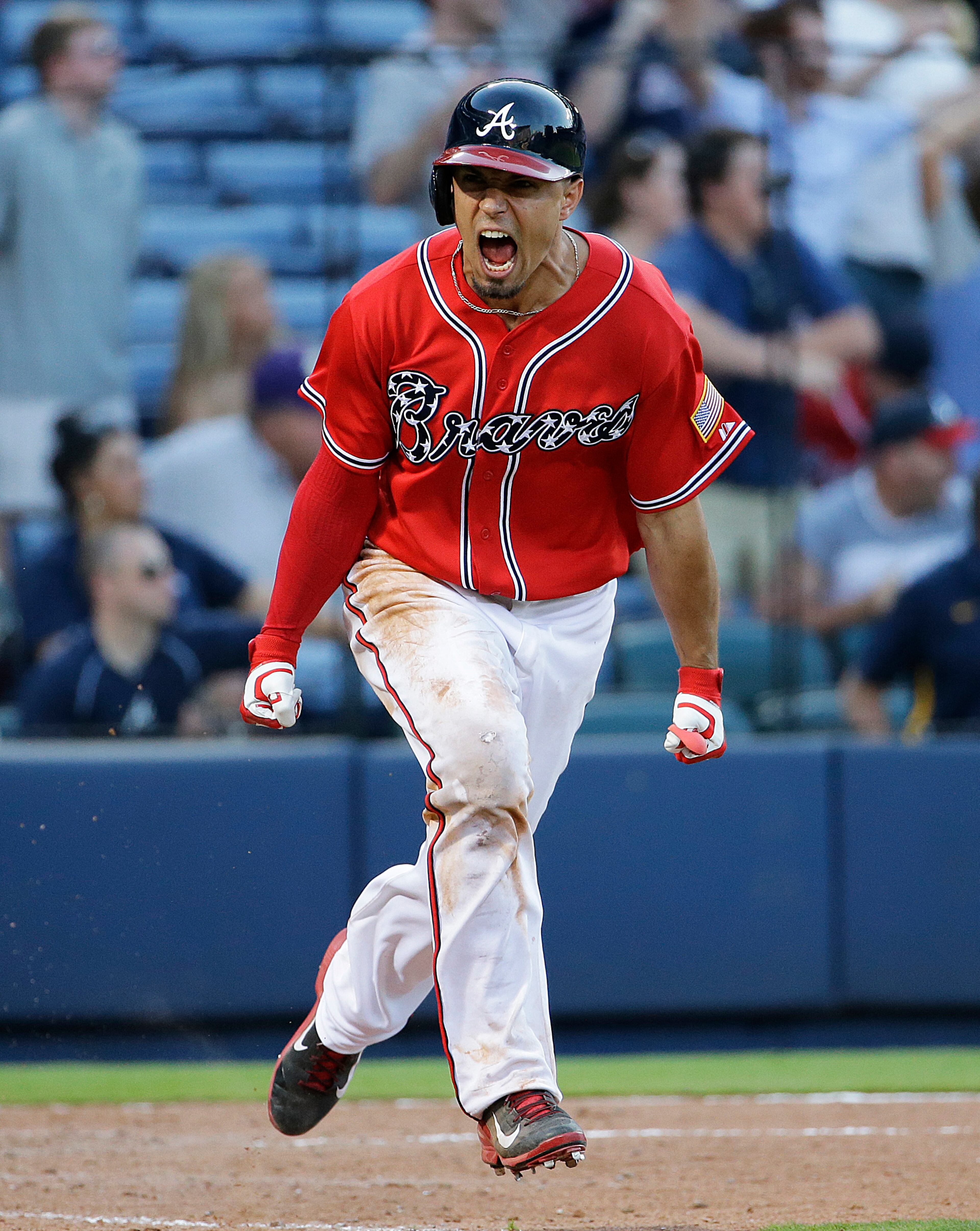 Atlanta Braves' Jace Peterson celebrates after hitting the game-winning single to score teammate Alberto Callaspo in the eleventh inning of a baseball game against the Milwaukee Brewers Saturday, May 23, 2015, in Atlanta. The Braves won 3-2. (AP Photo/David Goldman)