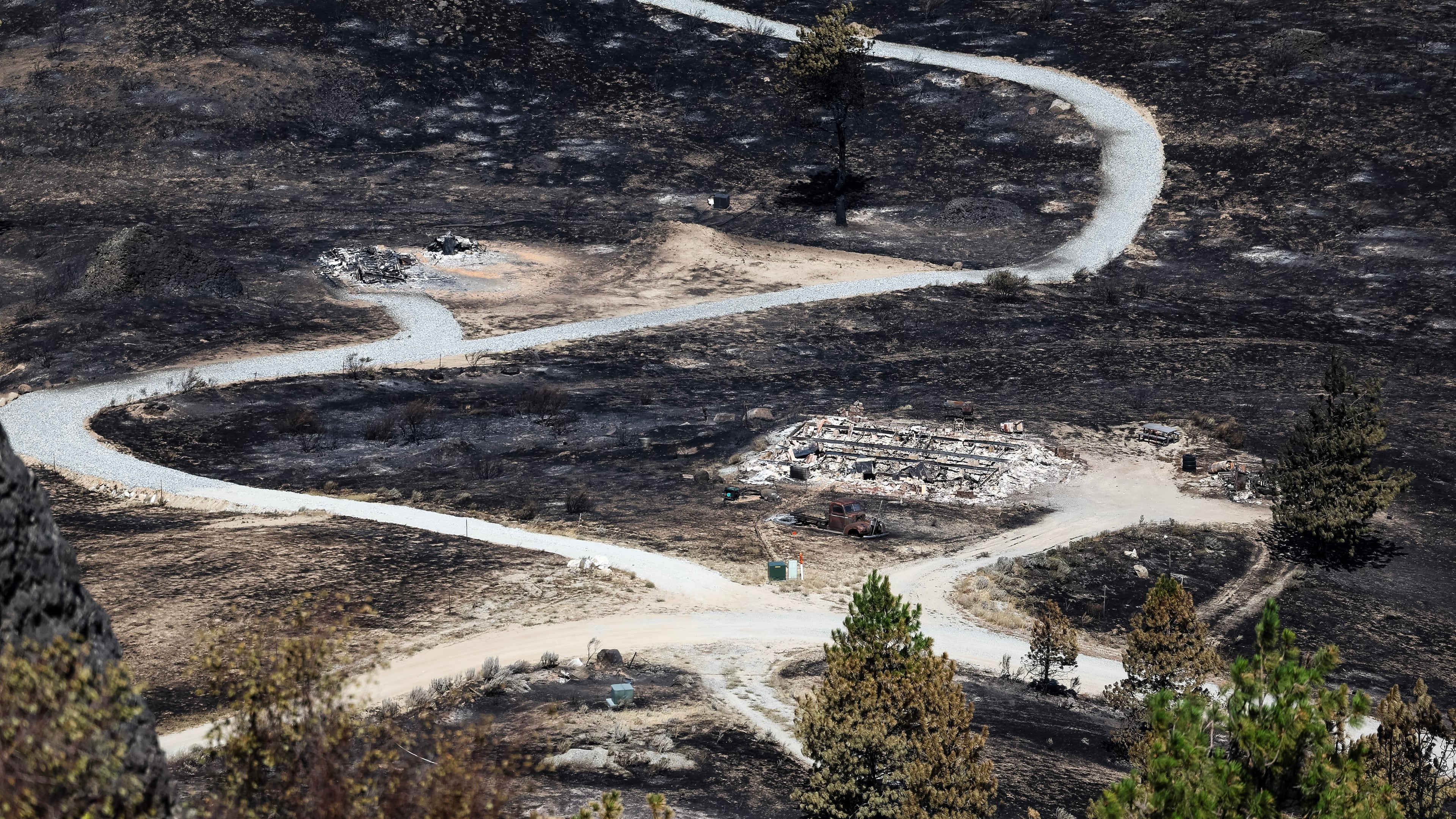 Debris from a burnt house is scattered after the Chelan Hills Fire burned through McNeil Canyon on Wednesday, July 8, 2026, in Orondo, Wash. (Nick Wagner/The Seattle Times via AP)