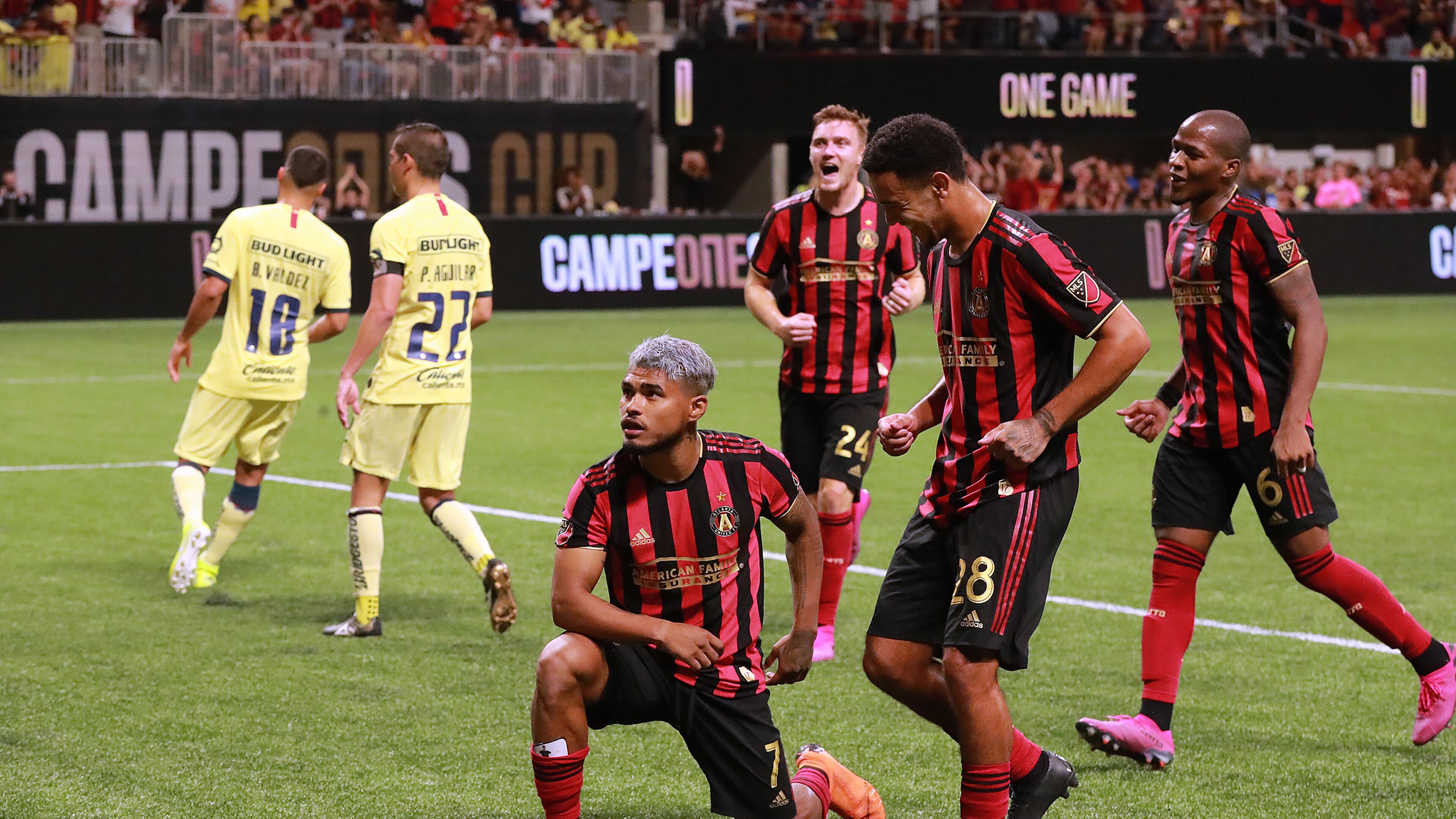 August 14, 2019 Atlanta: Atlanta United forward Josef Martinez strikes a pose for the fans after making what turned out to be the winning goal on a penalty kick for a 3-2 victory over Club America as teammates arrive to celebrate in the Campeones Cup on Wednesday, August 14, 2019, in Atlanta. Curtis Compton/ccompton@ajc.com