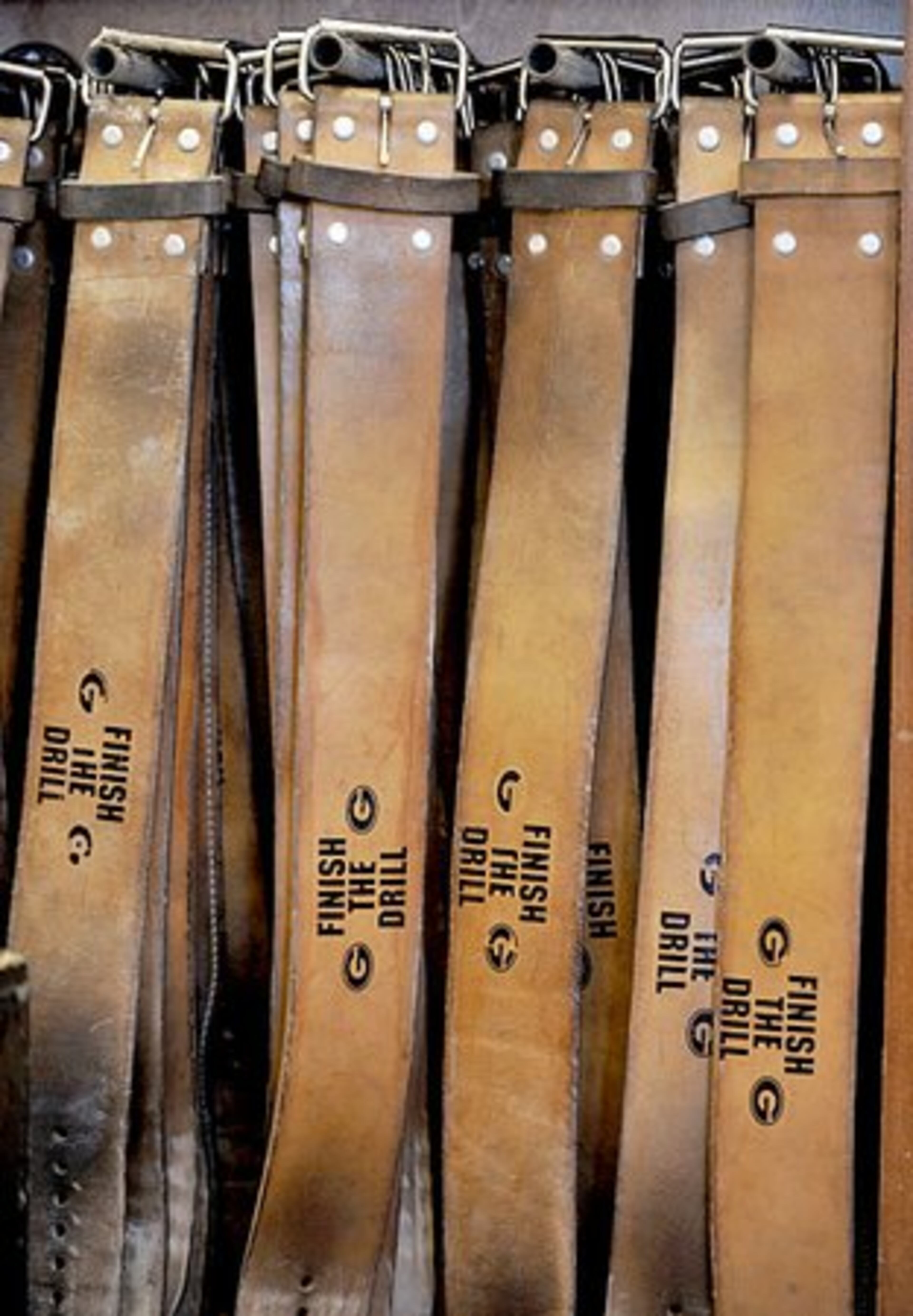Well used weight belts give players Georgia's inspirational motto "Finish the Drill."