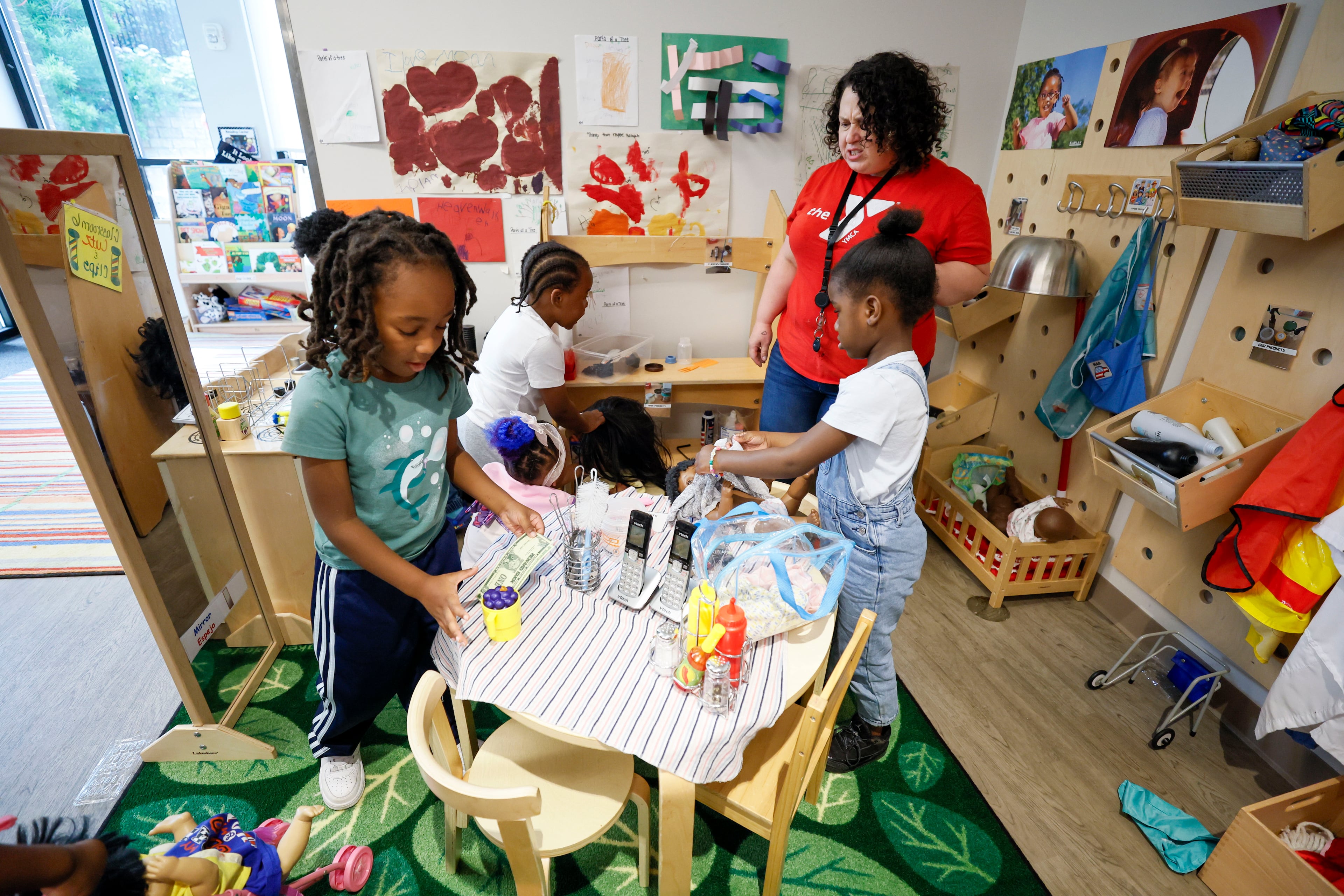 Children in the Head Start program engage in indoor activities with lead teacher Genesis Lavanway during the 60th birthday of the federal Head Start program on Monday. (Miguel Martinez/AJC)
