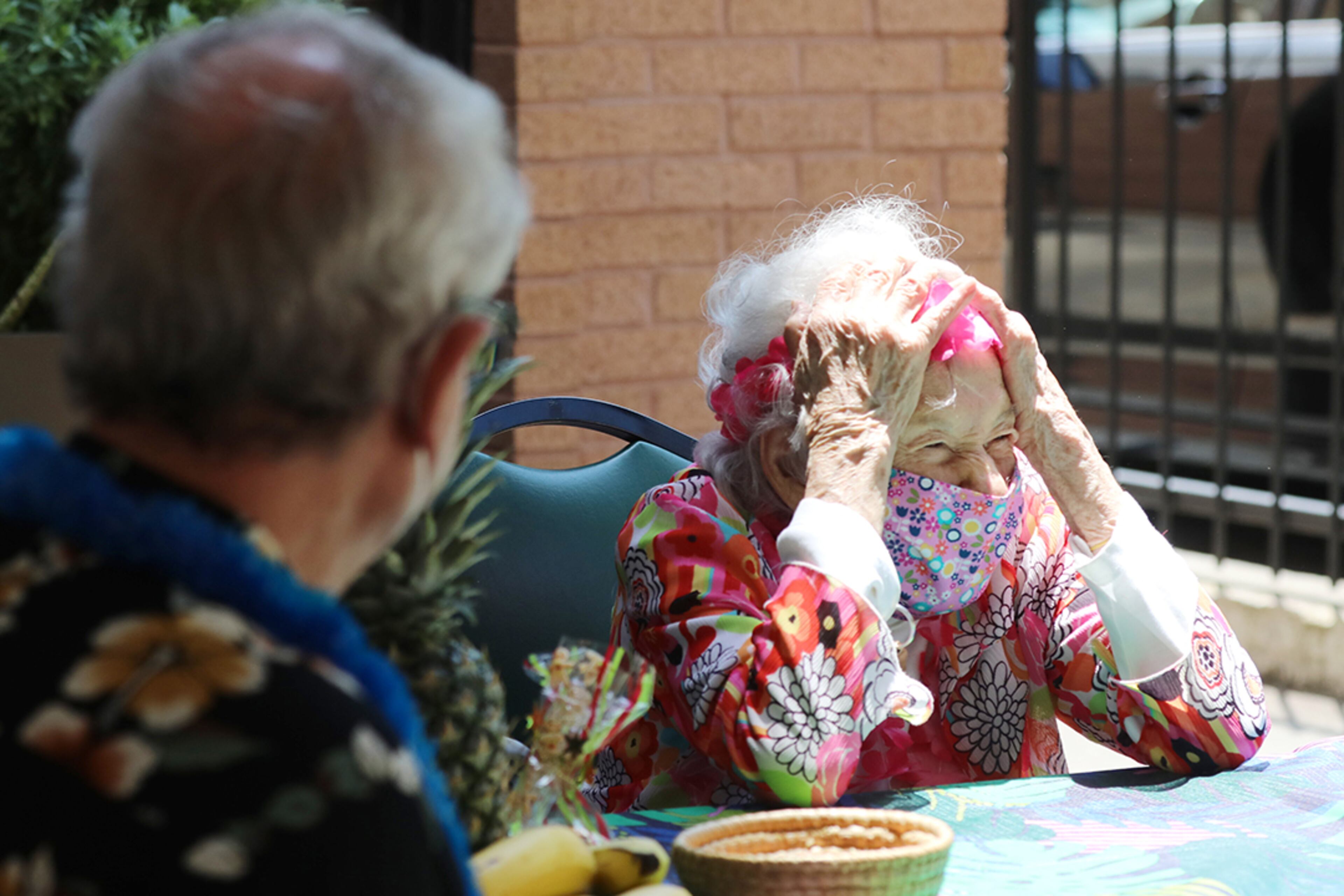 Peggy Cobb of Sandy Springs reacts to seeing friends and family members arrive at the Hammond Glen Retirement Community for her 105th birthday celebration on
Friday, May 22, 2020. (Photo: Miguel Martinez for The Atlanta Journal-Constitution)