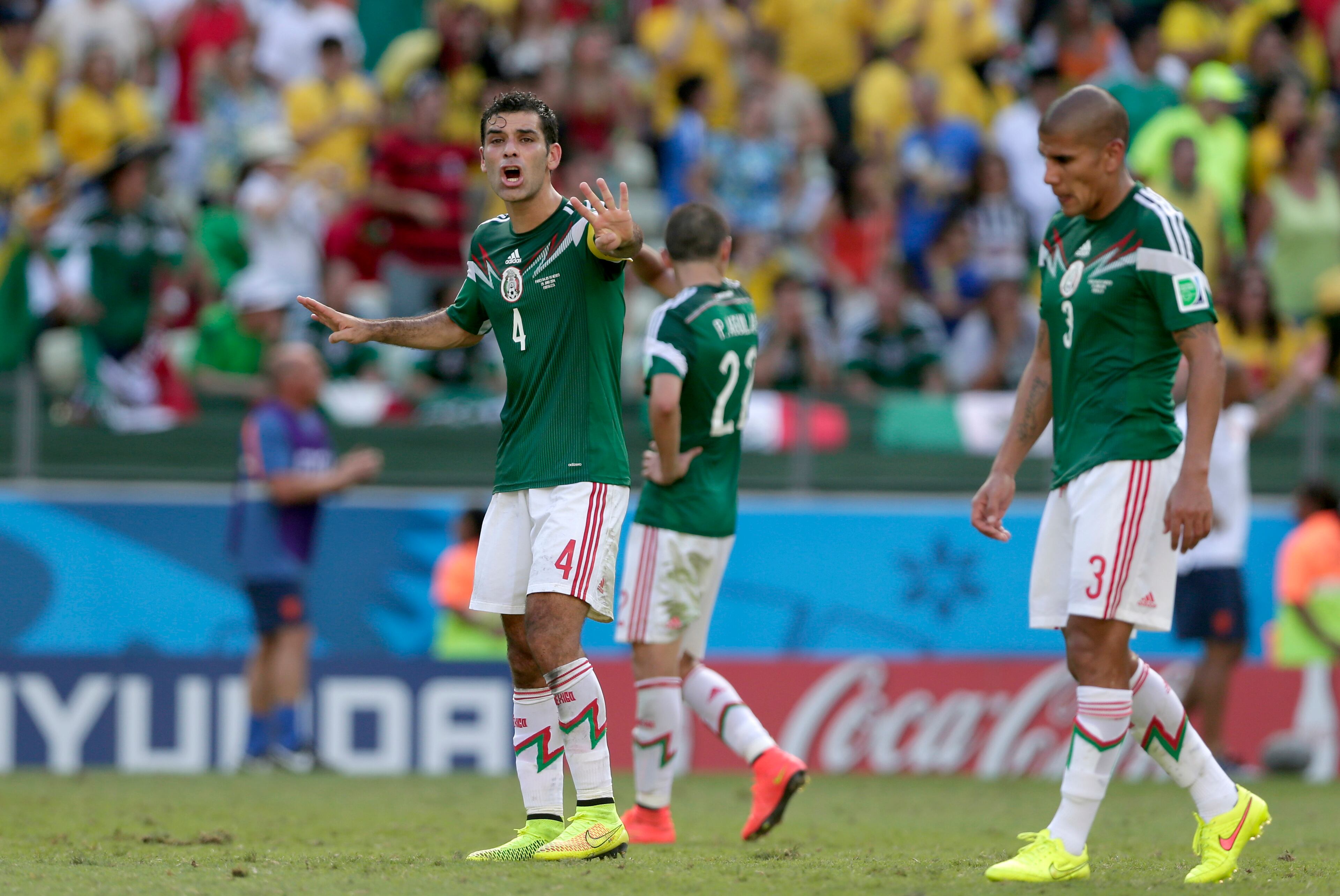 Mexico's Rafael Marquez, left, instructs his teammates after the Netherlands scored their second goal during the World Cup round of 16 soccer match between the Netherlands and Mexico at the Arena Castelao in Fortaleza, Brazil, Sunday, June 29, 2014. (AP Photo/Marcio Jose Sanchez)